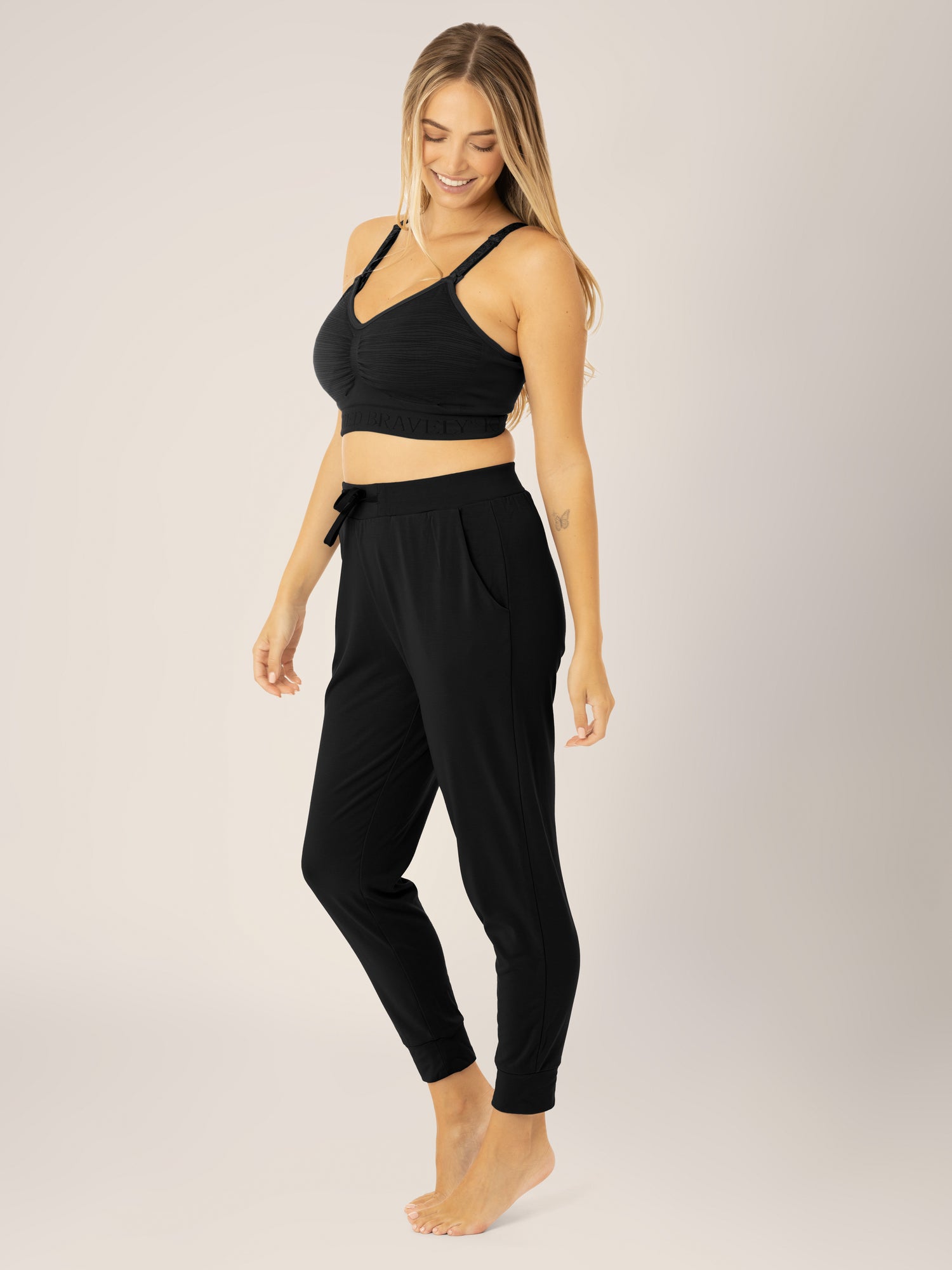 Busty model wearing the Sublime® Hands-Free Pumping & Nursing Bra in Black