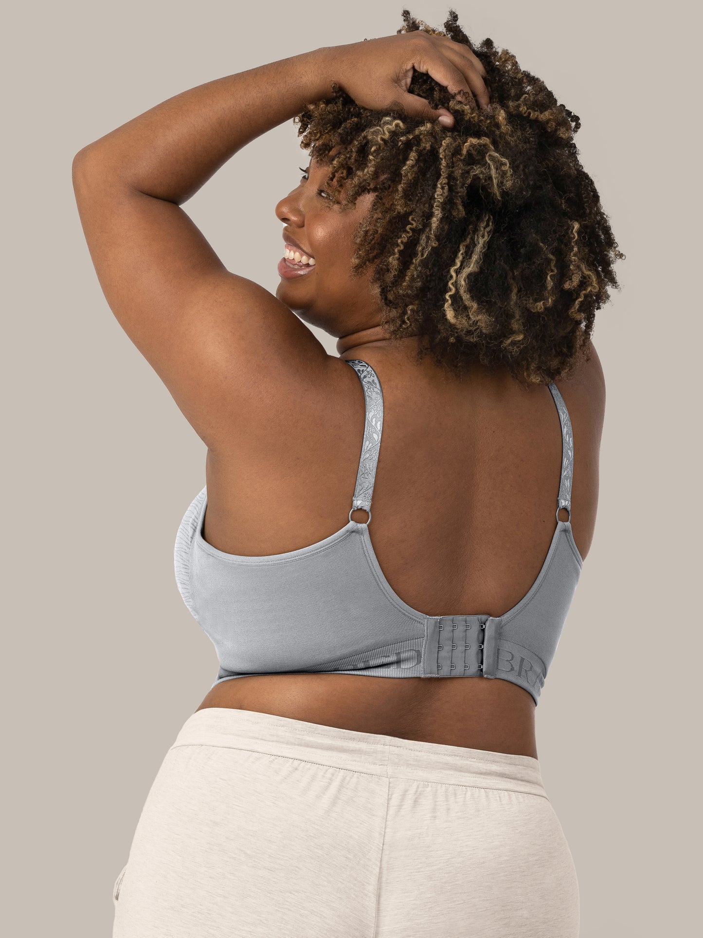 The back of a model wearing the Sublime® Hands-Free Pumping & Nursing Bra in Grey