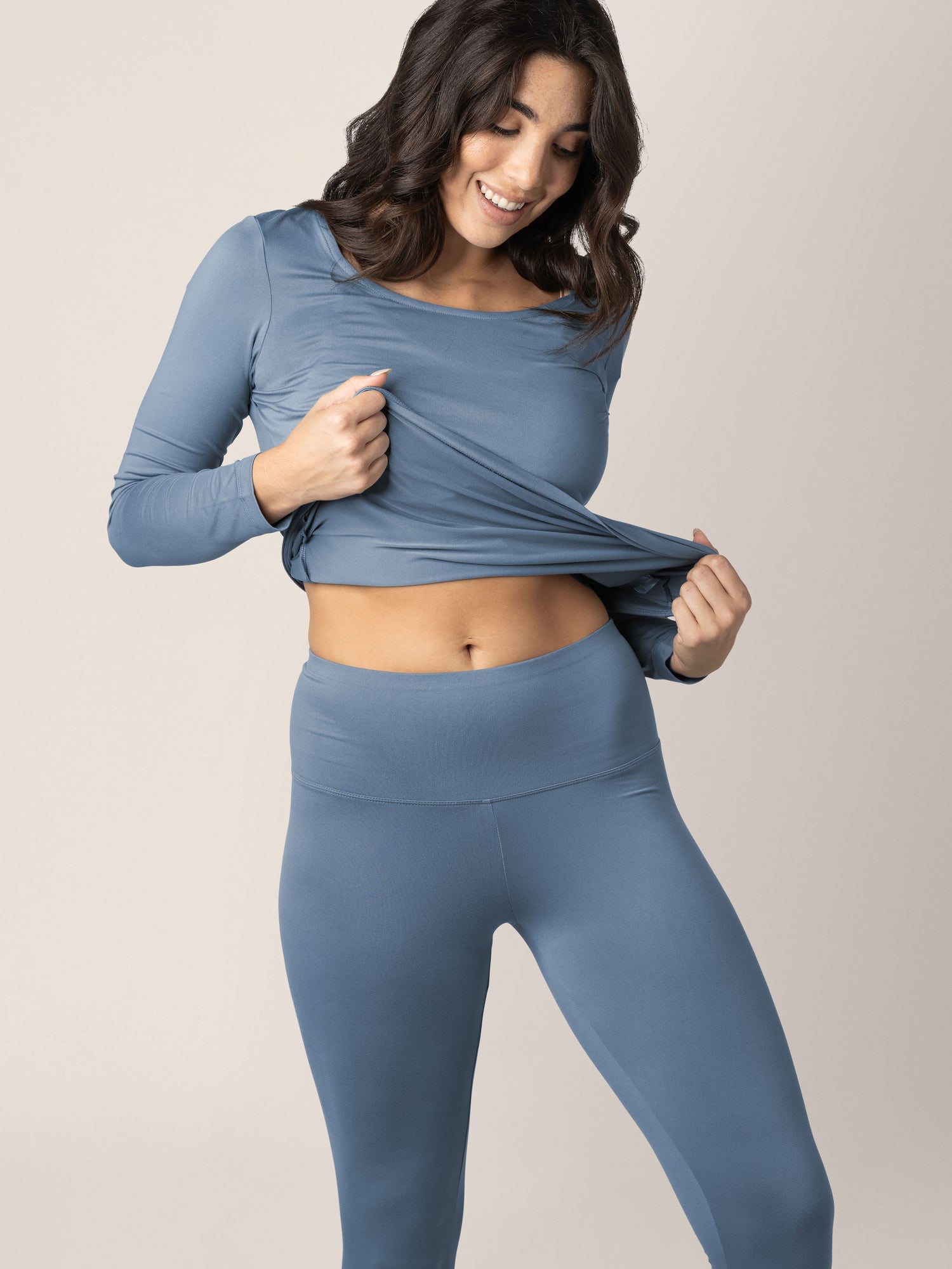 Model wearing the Jane Nursing Pajama Set in Slate Blue holding onto the Hem