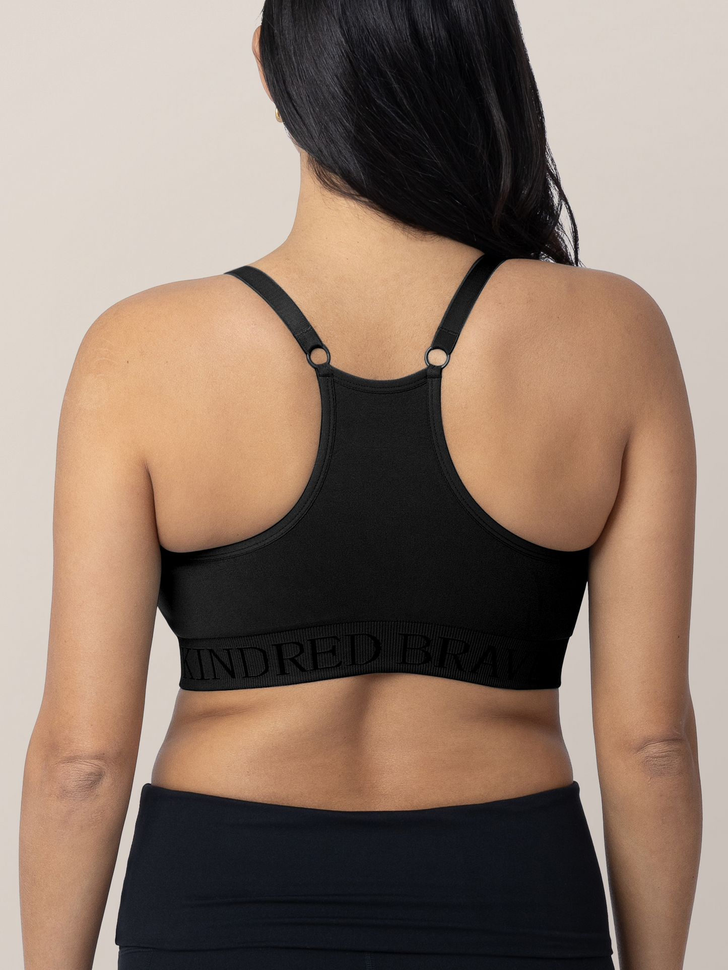 Back of a model wearing the Sublime® Hands-Free Pumping & Nursing Sports Bra in Black