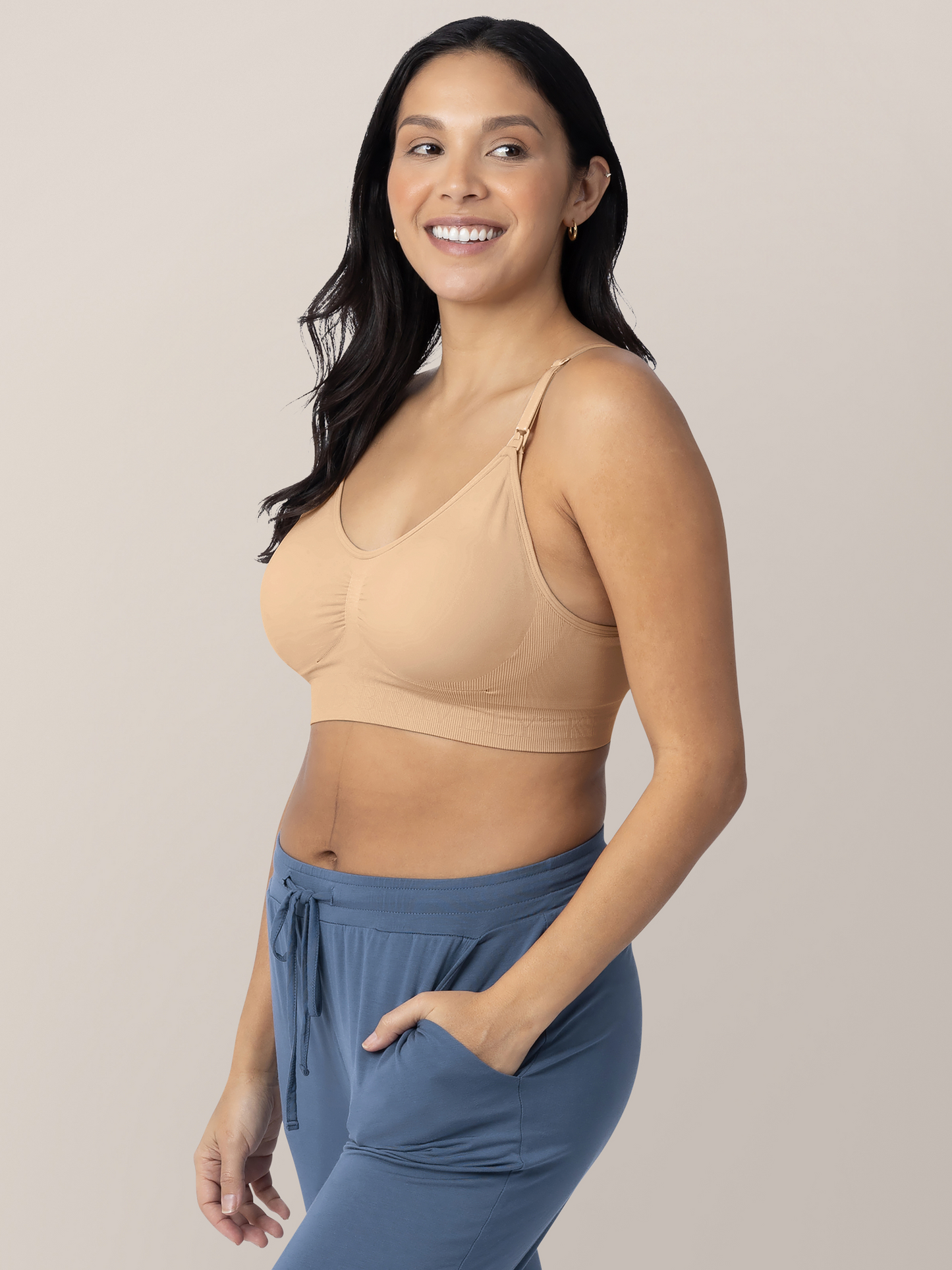 Model wearing the Simply Sublime® Nursing Bra in Beige with her hand in her pocket. 