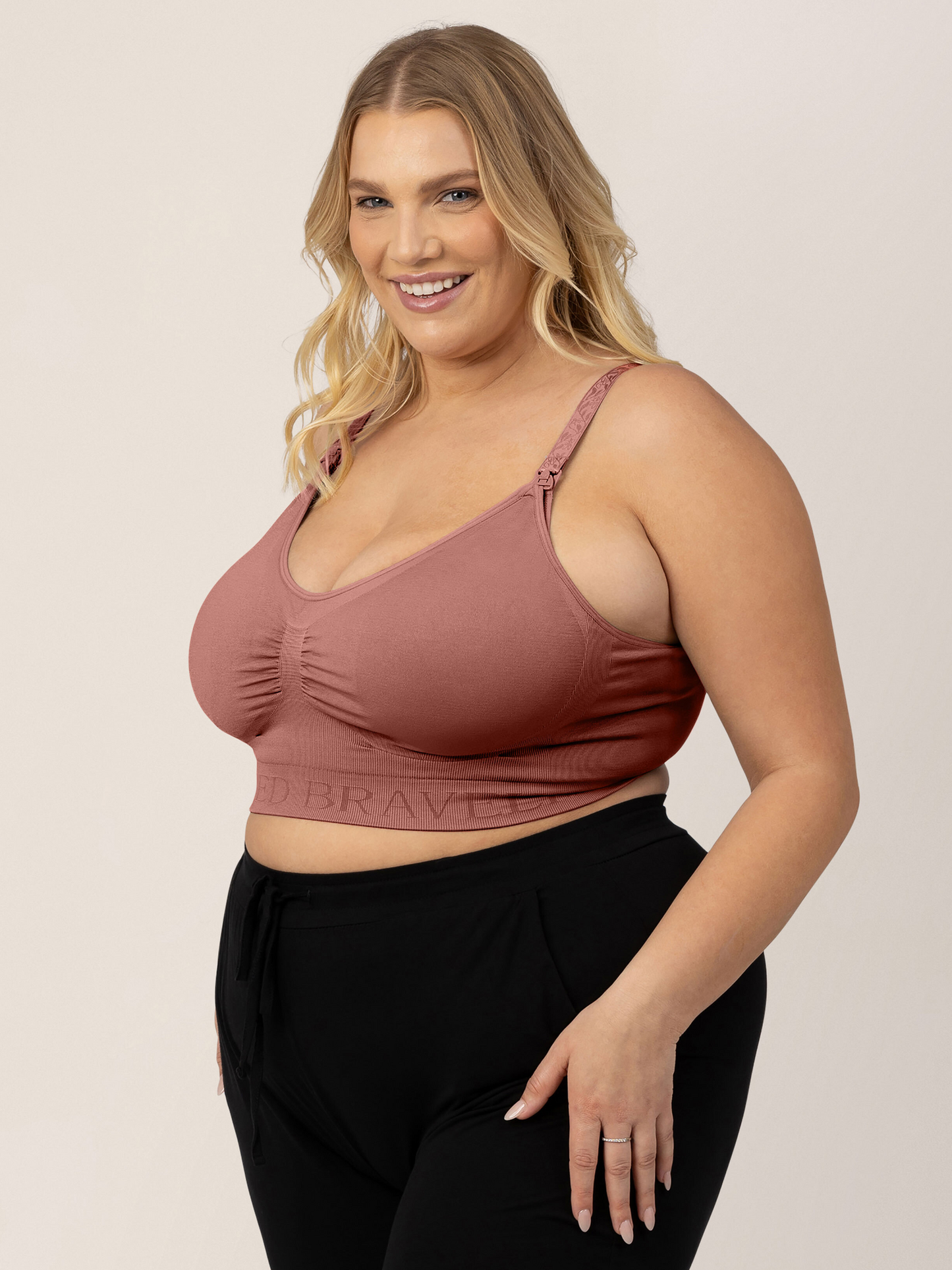 Model wearing the Simply Sublime® Nursing Bra in Redwood with her hand on her thigh.