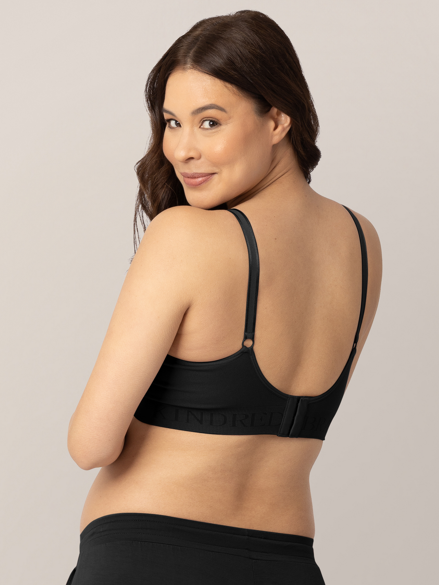 Back of a pregnant model looking over her shoulder while wearing the Simply Sublime® Nursing Bra in Black