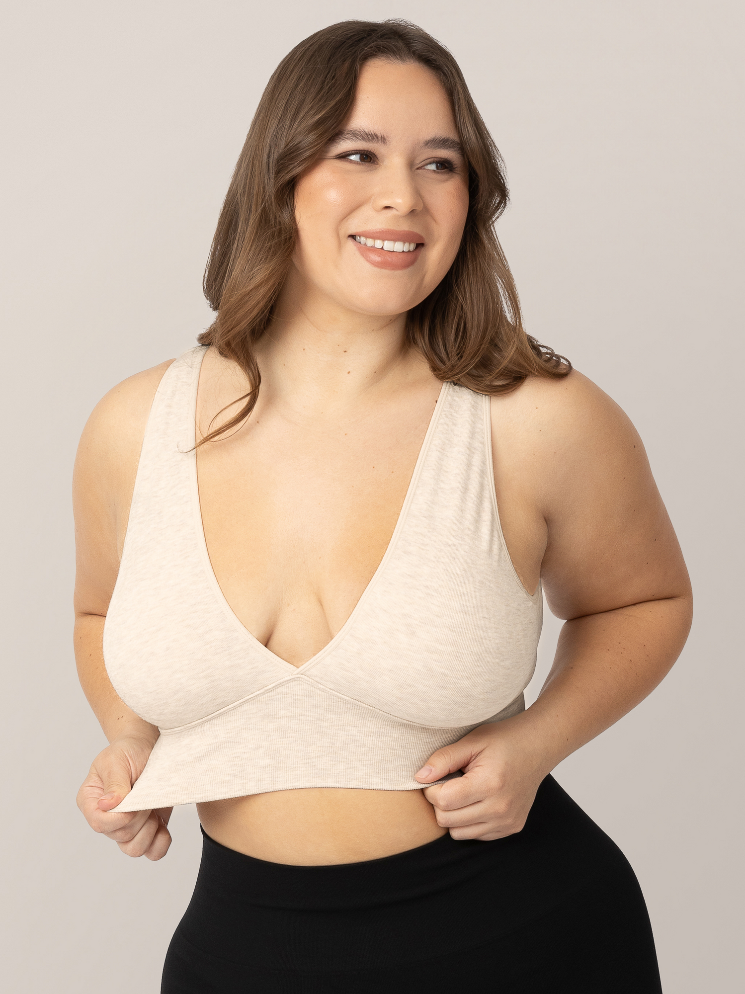 Model wearing the Sublime Bamboo Maternity & Nursing Plunge Bra in Oatmeal Heather, showing stretch of fabric.@model_info:Venezia is wearing a Large.