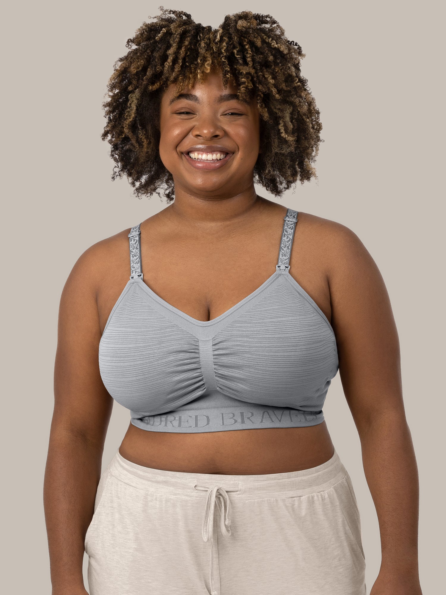 The front of a model wearing the Sublime® Hands-Free Pumping & Nursing Bra in Grey