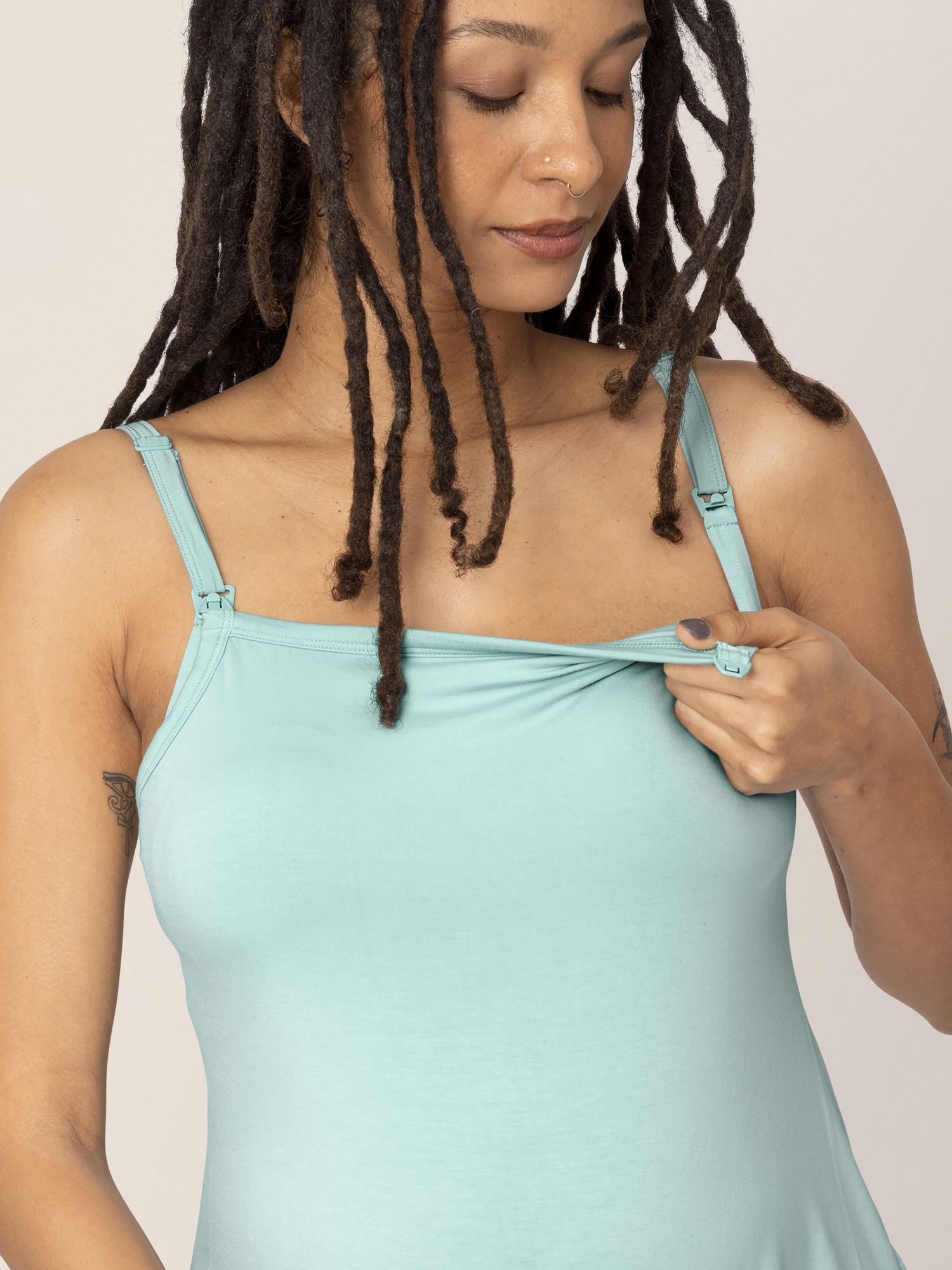 Closeup of a model wearing the Bamboo Lounge Around Nursing Tank in Dusty Blue Green.