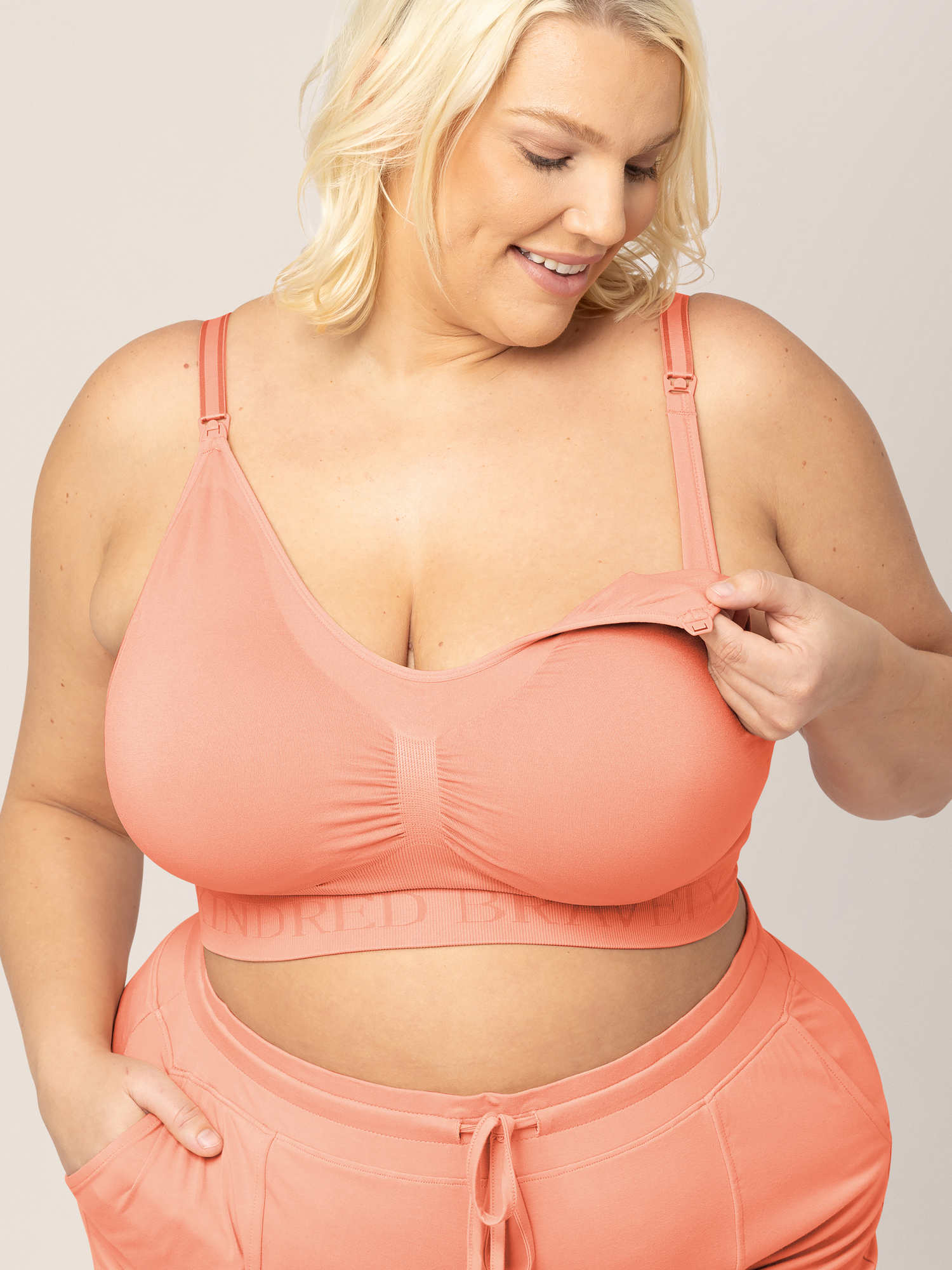 Model showing the clip down nursing access on the Simply Sublime® Nursing Bra in Vintage Coral