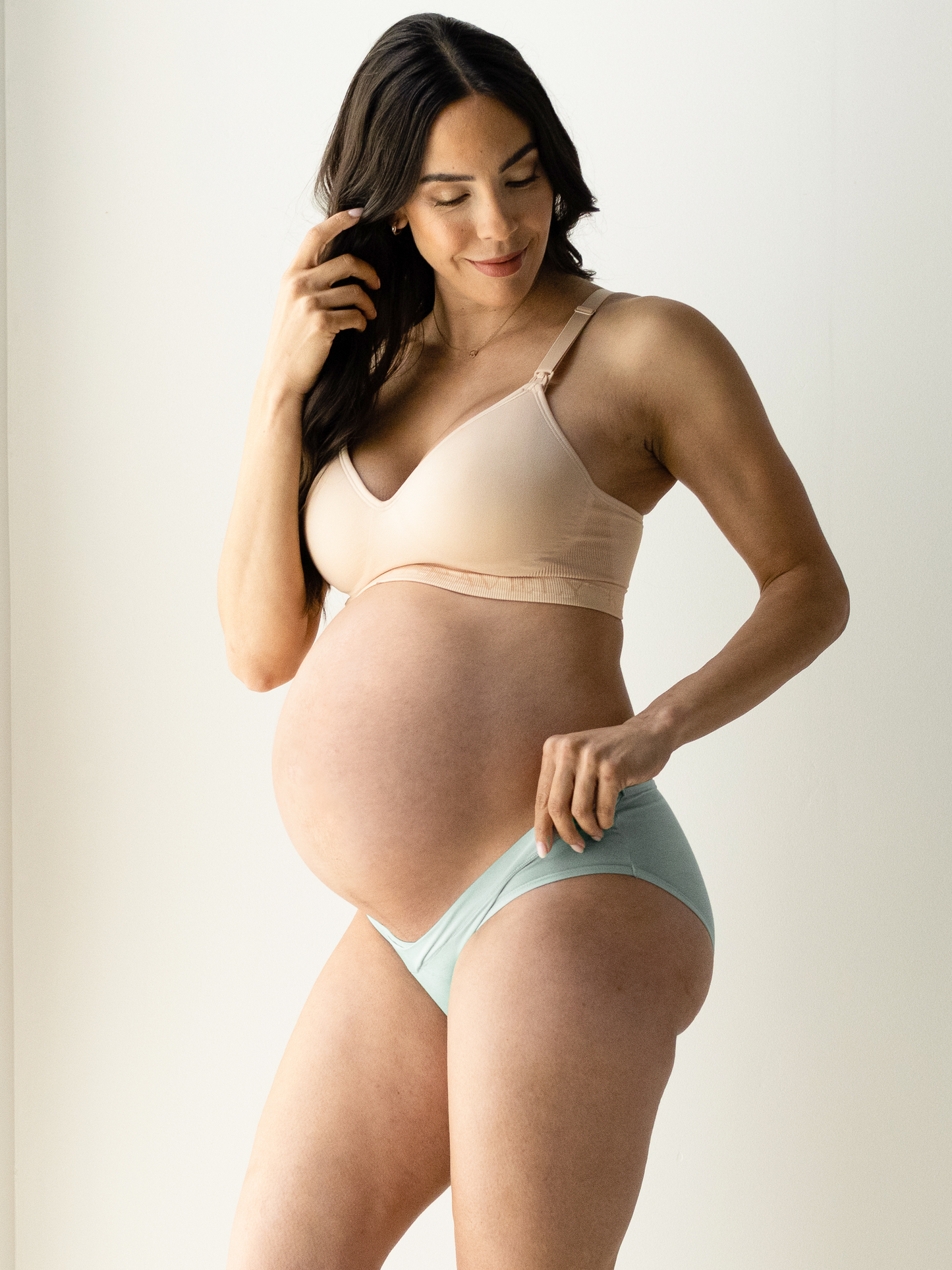 Close up of a pregnant model wearing the Under-the-Bump Bikini Underwear in assorted colors @model_info:Susy is wearing a Small.