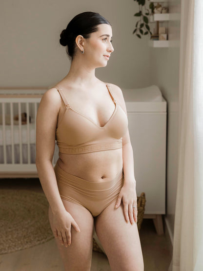 Model wearing the Signature Sublime® Contour Maternity & Nursing Bra in Beige with her hands on her hips. @model_info:Kianna is wearing a Small Regular.
