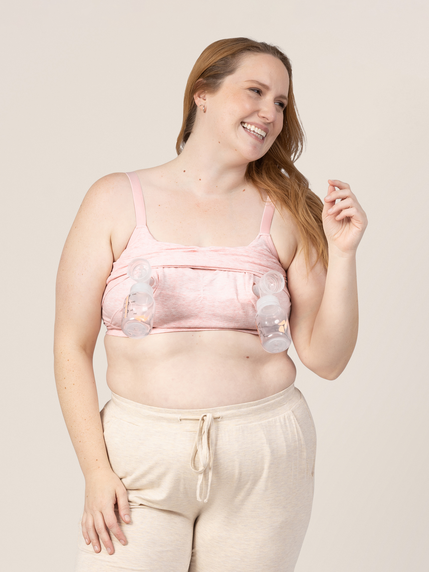 Model pumping while connected to the Sublime® Bamboo Hands-Free Pumping Lounge & Sleep Bra in Pink Heather