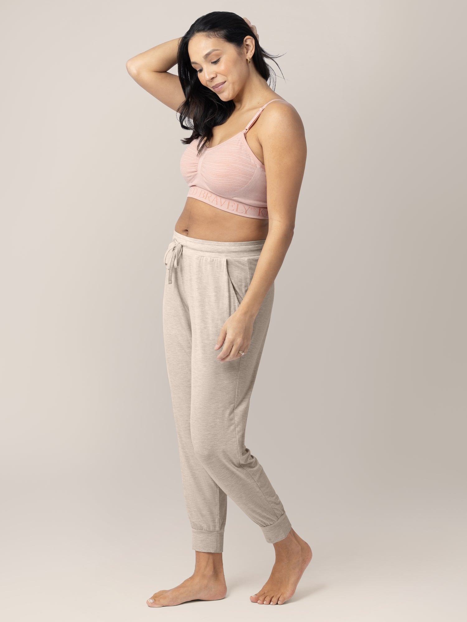 Model with her hand in her hair wearing the Sublime® Hands-Free Pumping & Nursing Bra in Pink Heather