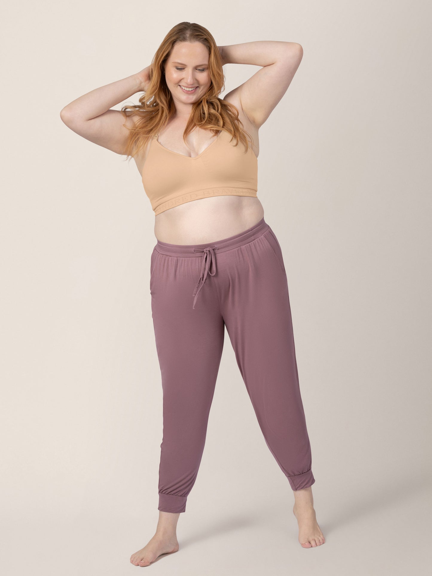 Full body view of a model wearing the Signature Sublime® Contour Hands-Free Pumping & Nursing Bra in Beige