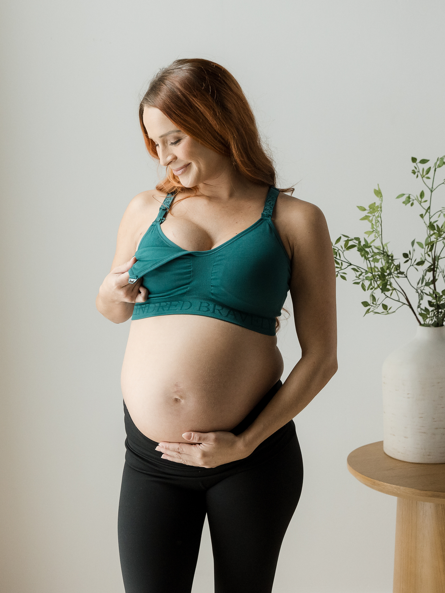 Pregnant model wearing the Sublime® Hands-Free Pumping & Nursing Sports Bra in Teal.