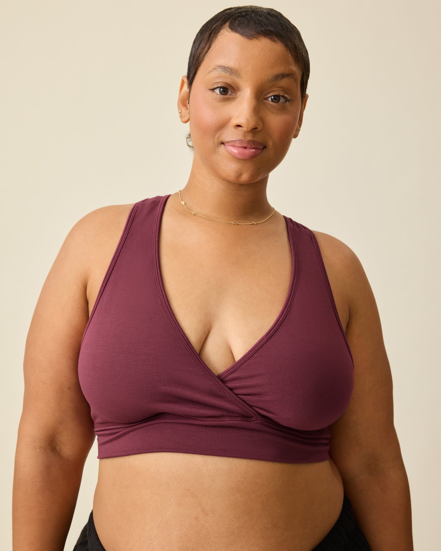 Model is wearing French Terry Racerback Nursing & Sleep Bra in Deep Burgundy on a beige background@model_info:Brittany is wearing an X-Large.