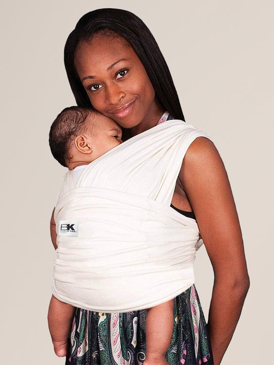 Model wearing baby in the Baby K'tan Organic Baby Carrier in Natural