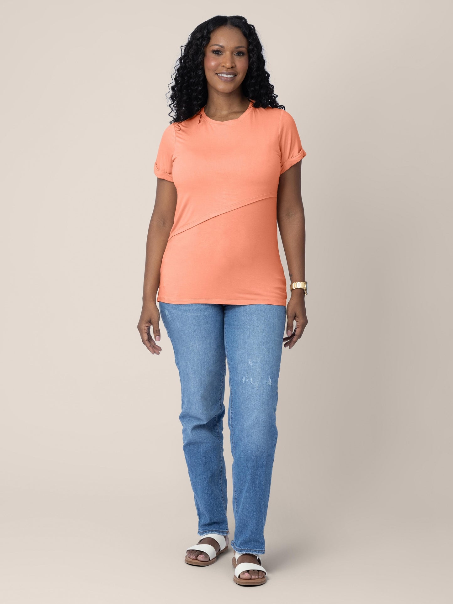 Full body of a Model wearing the Everyday Asymmetrical Nursing T-shirt in Vintage Coral.