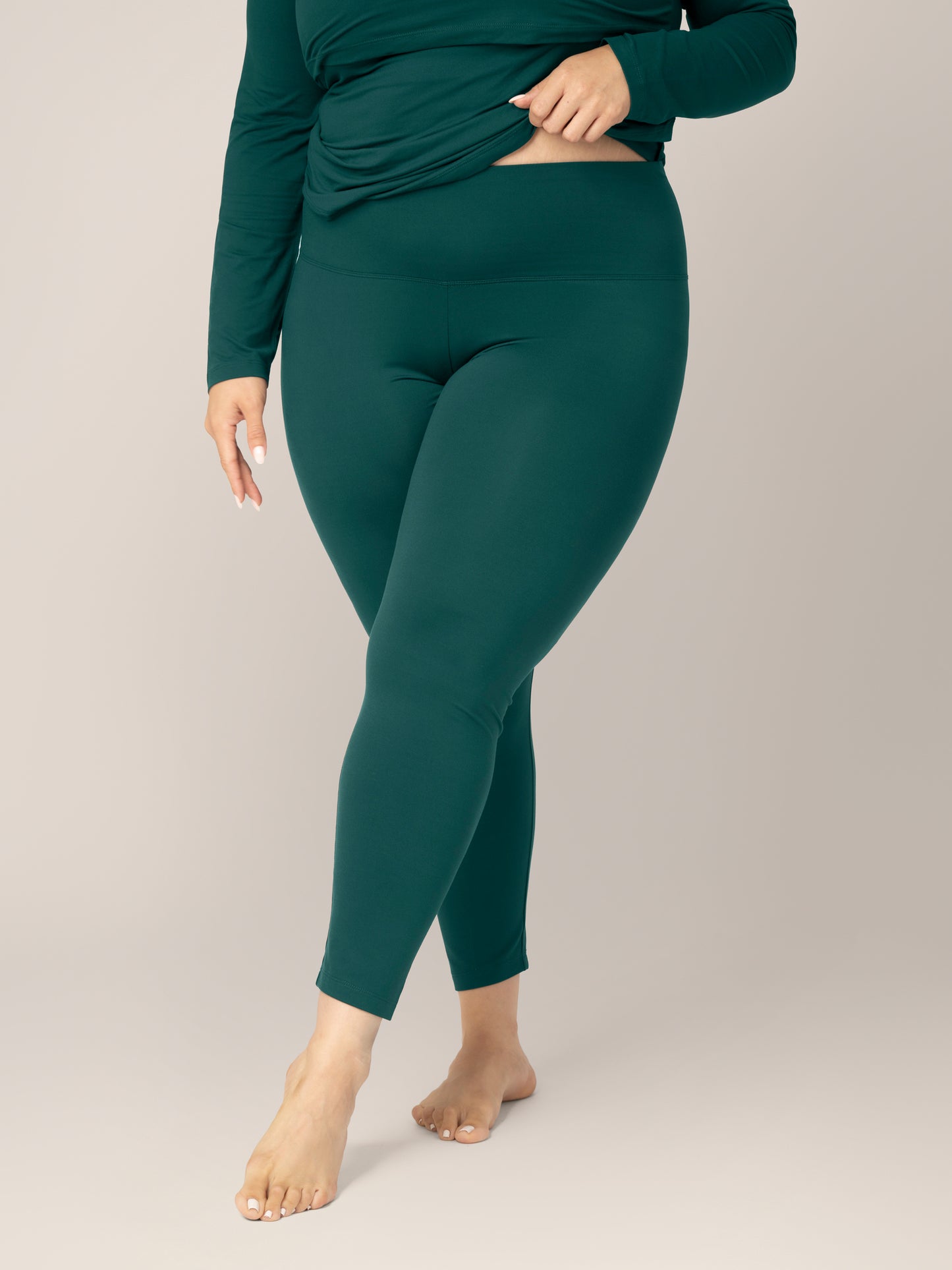 Front view of model wearing the Jane Nursing Pajama Set in Evergreen, cropped in to show bottoms and waistband