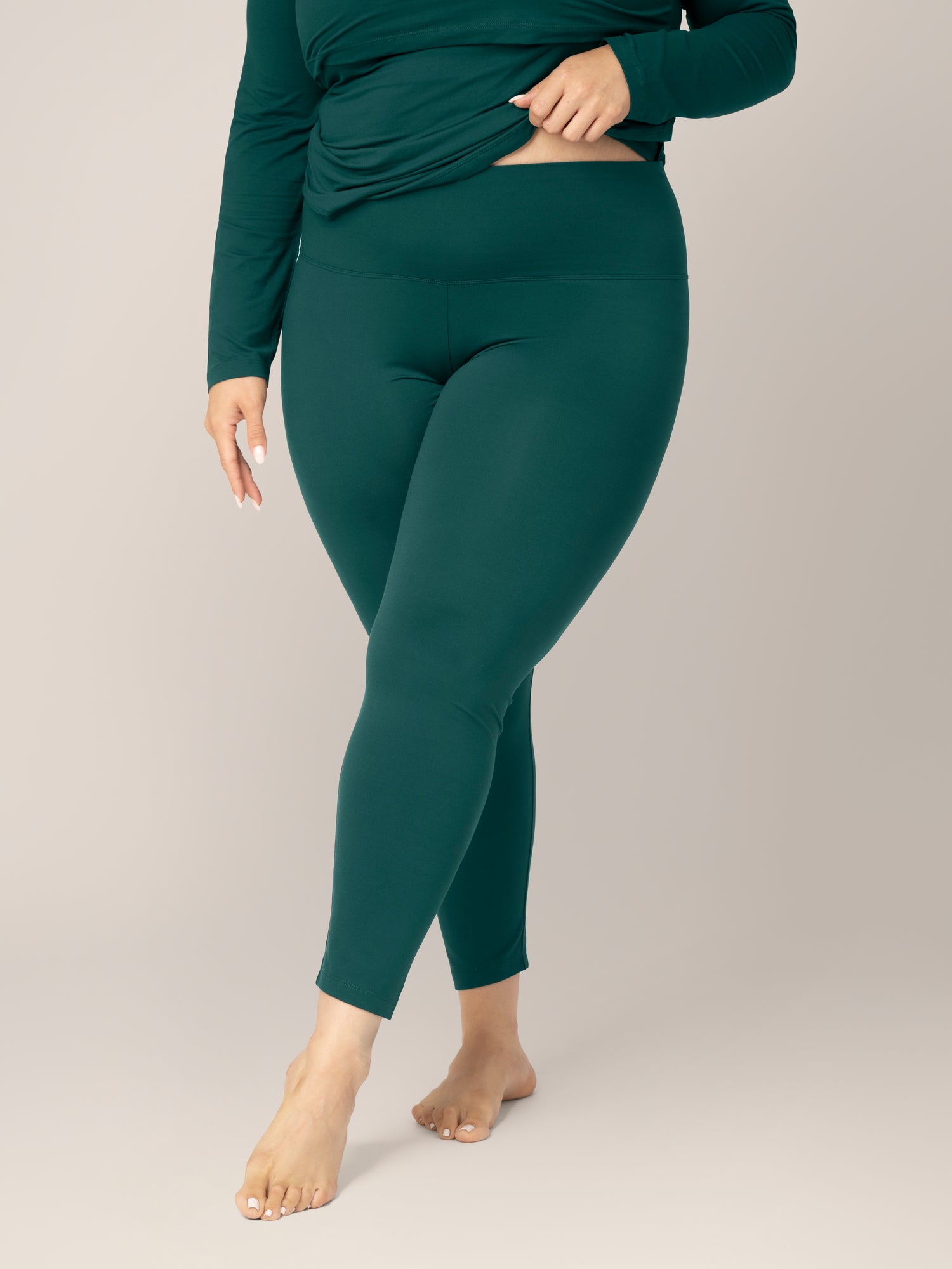 Front view of model wearing the Jane Nursing Pajama Set in Evergreen, cropped in to show bottoms and waistband