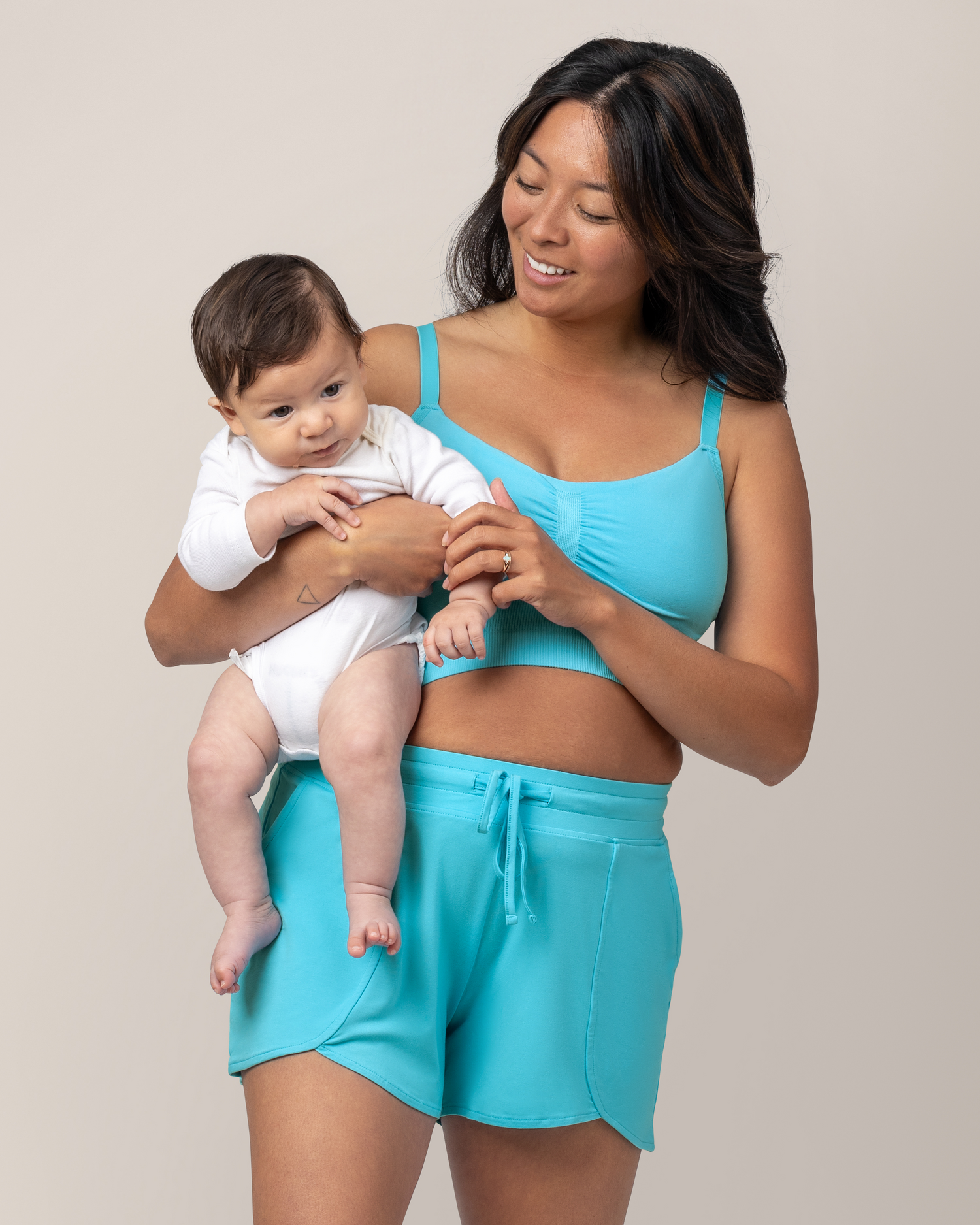 Front view of model holding baby while wearing Bamboo Maternity & Postpartum Lounge Short in Aquamarine  @model_info:Hillary is wearing a Medium.