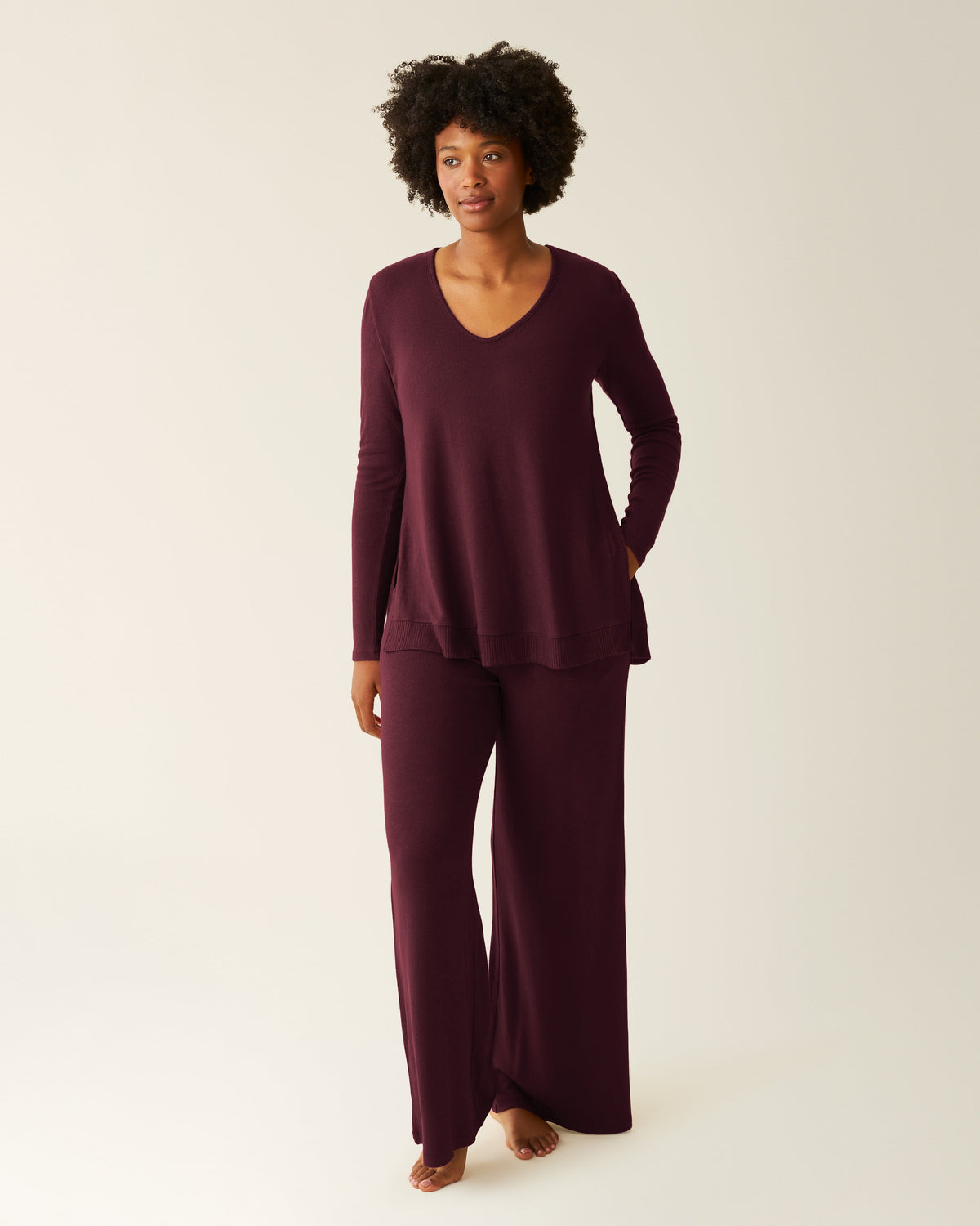 Front view of model wearing CozyKnit Maternity & Nursing V-neck Top in Deep Burgundy with CozyKnit Wide Leg Lounge Pant in Deep Burgundy on a beige background. @model_info:Kyra is 5'8" and wearing Small.