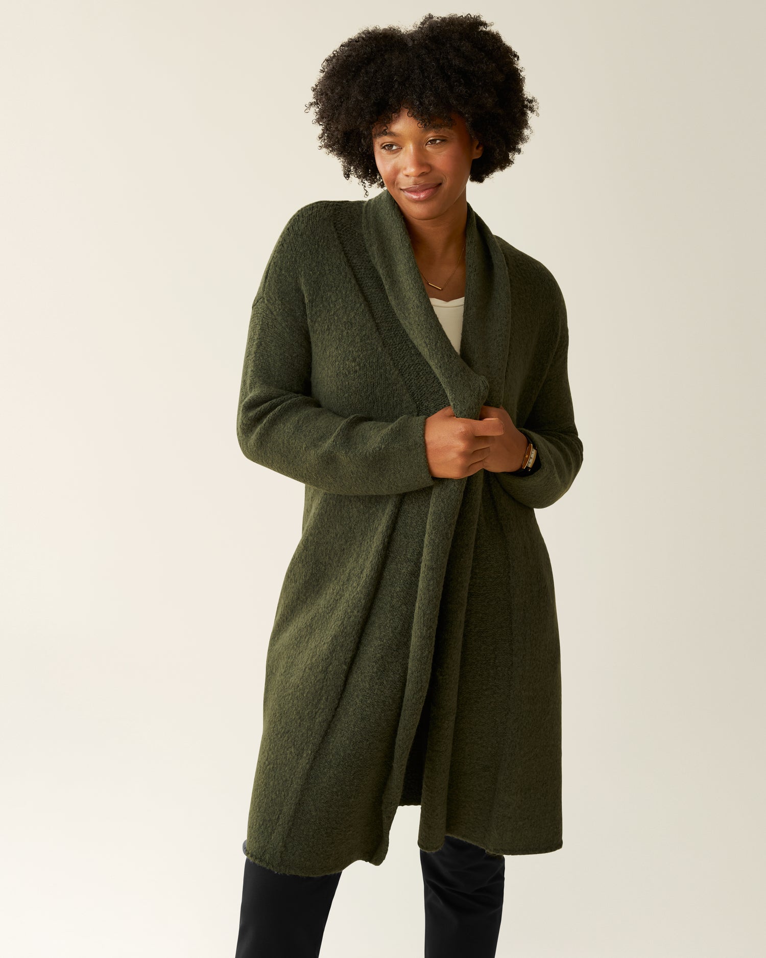 Woman wearing the Chloe Cardigan Sweater in Thyme@model_info:Kyra is 5'9" and wearing an XS/S.