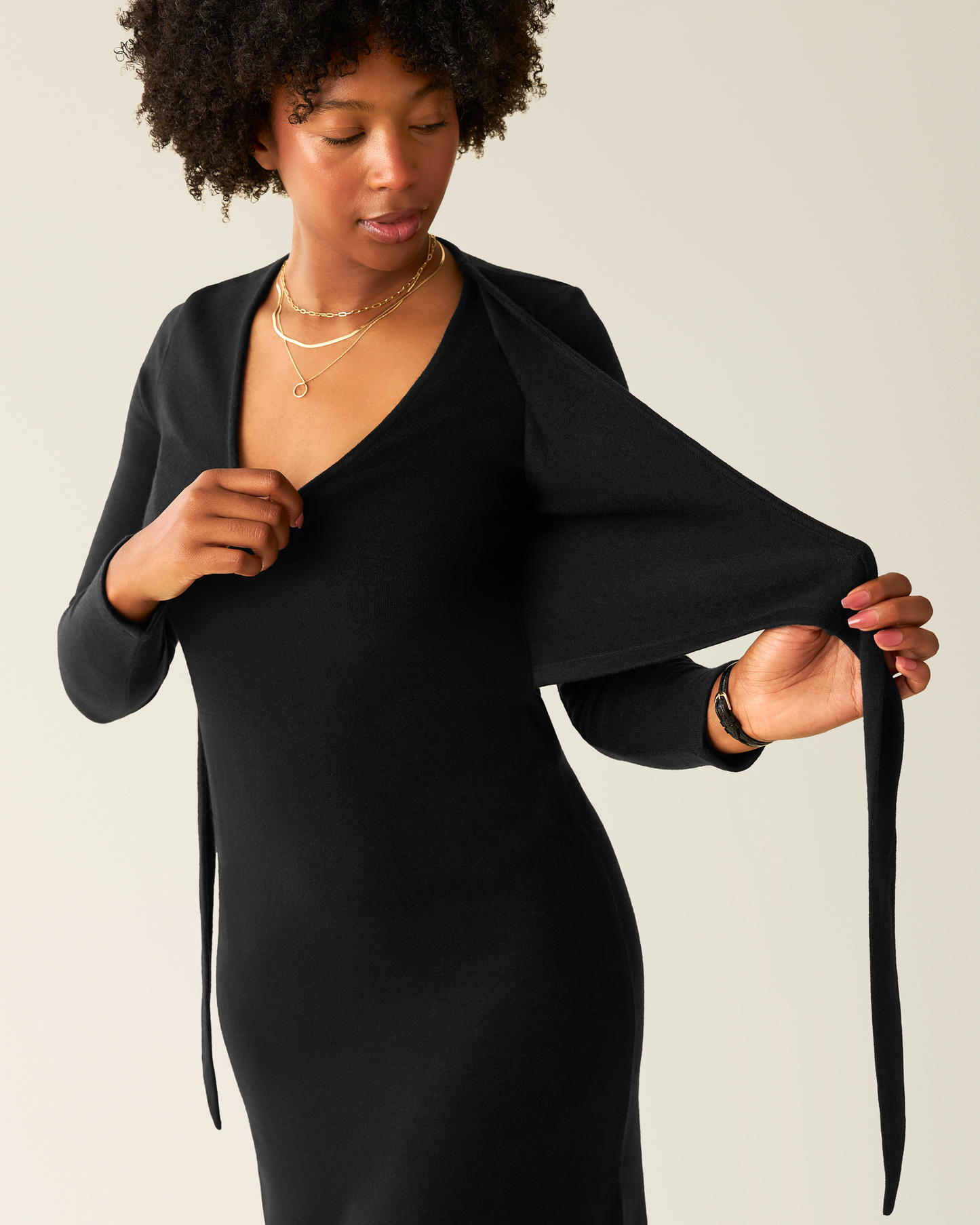 Model wearing Kate Nursing Wrap Sweater Dress in Black, showing nursing access