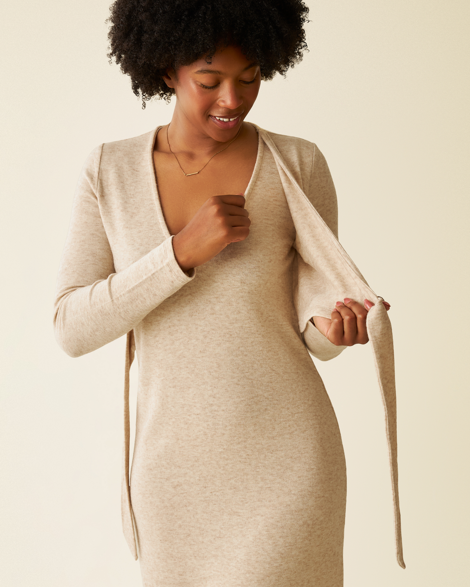 Model wearing Kate Nursing Wrap Sweater Dress in Oat showing nursing access