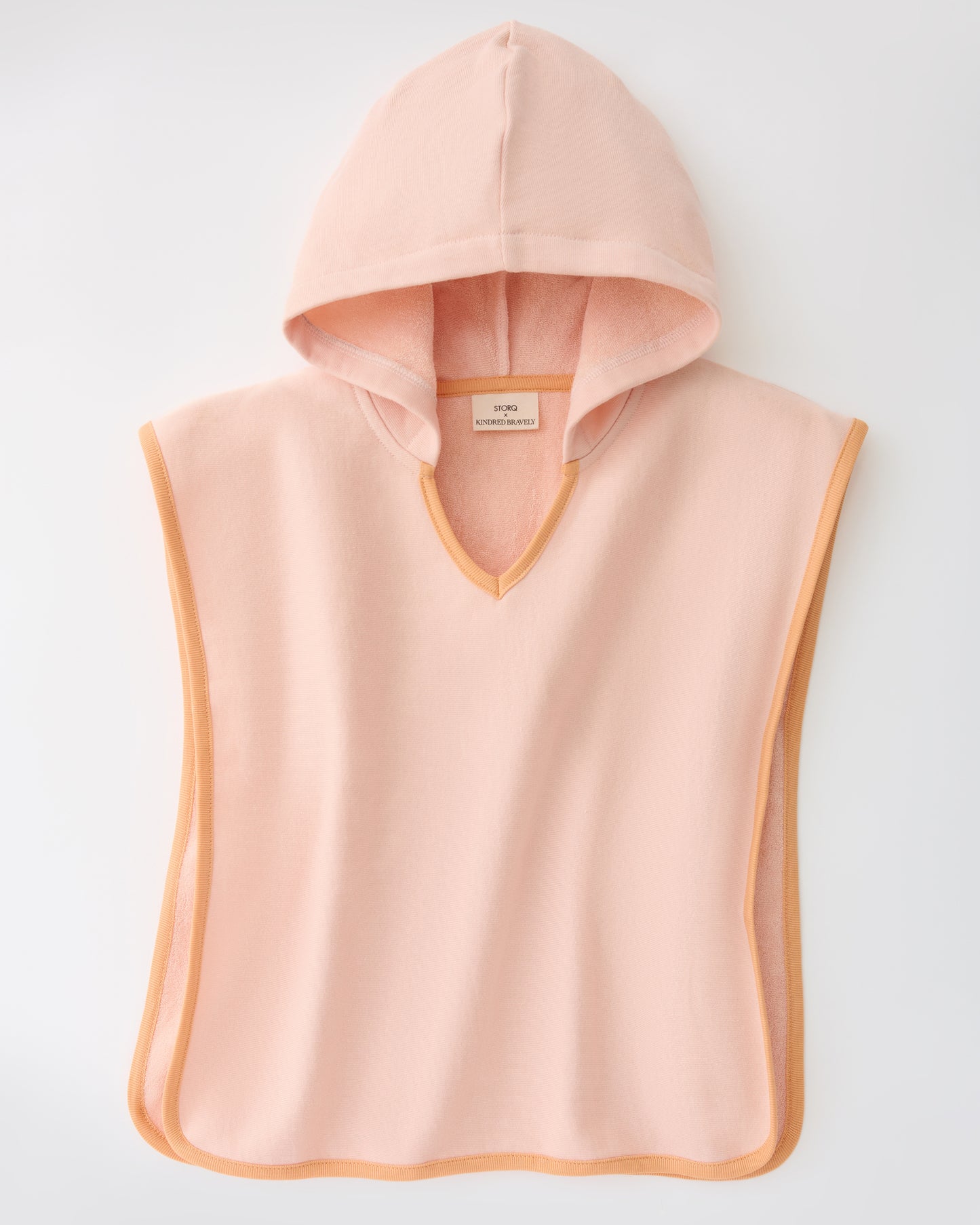 Toddler Poncho Towel in Peach Whip on a beige background
