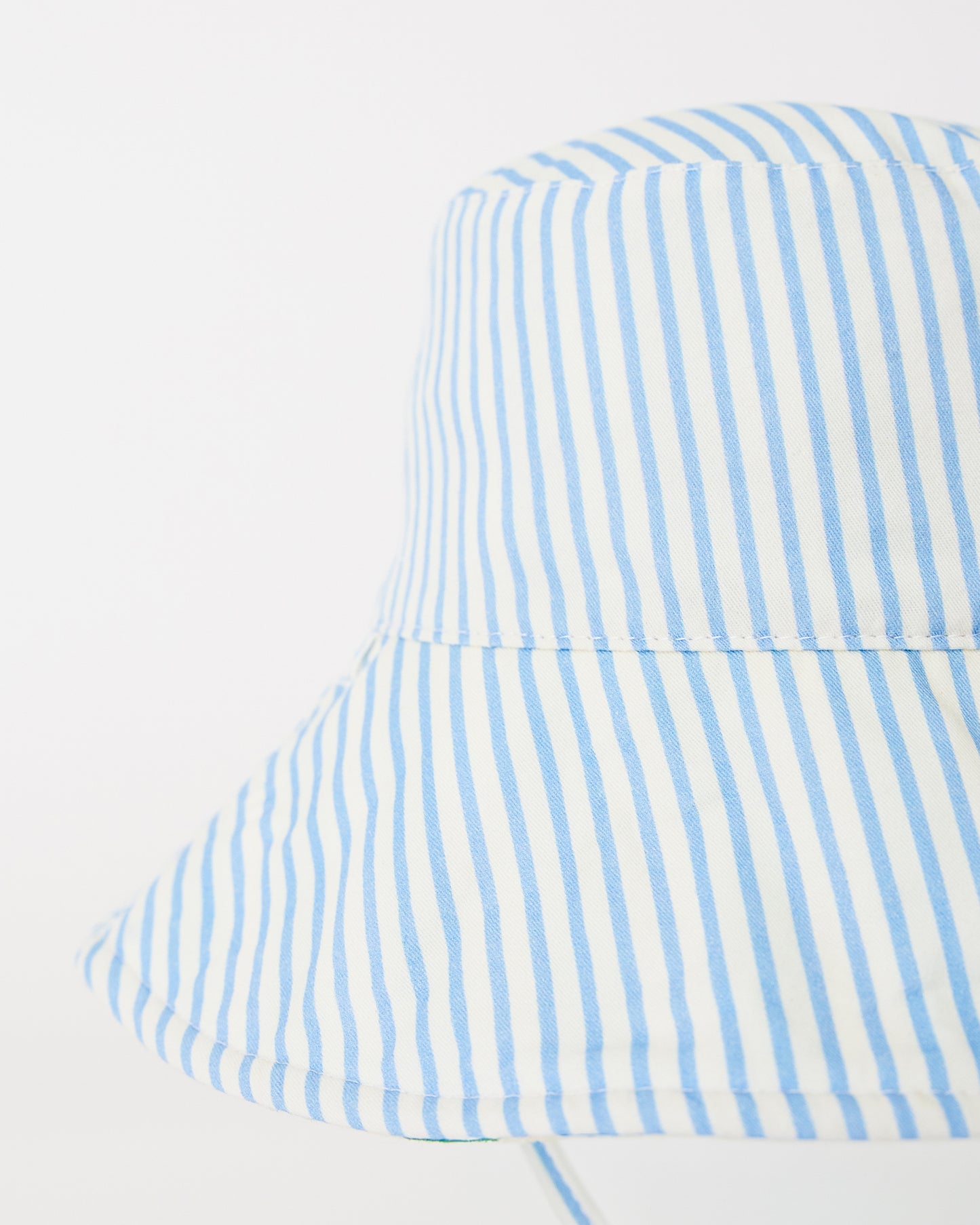 Close up of Toddler Sun Hat in Blue Pinstripe on a beige background