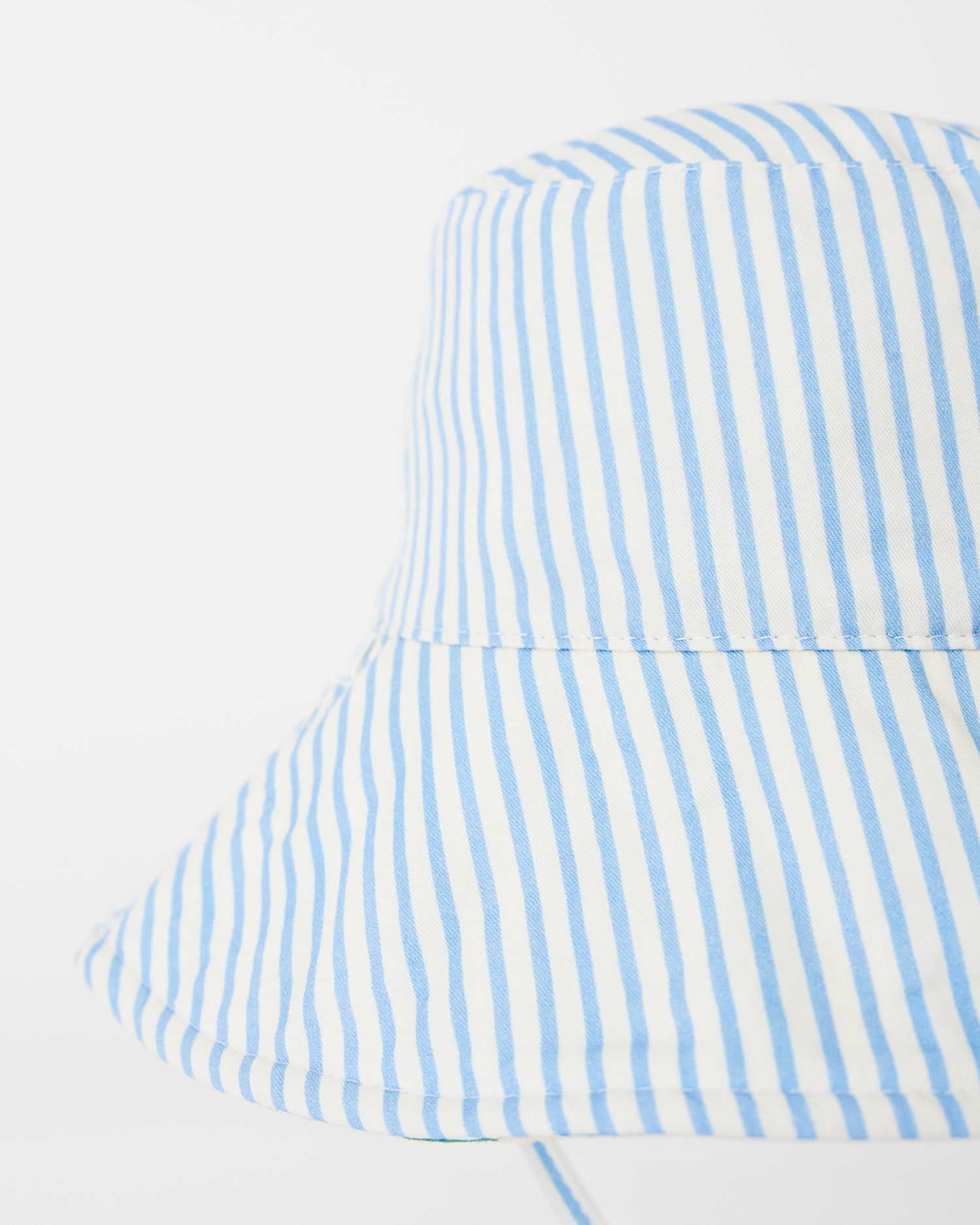 Close up of Toddler Sun Hat in Blue Pinstripe on a beige background