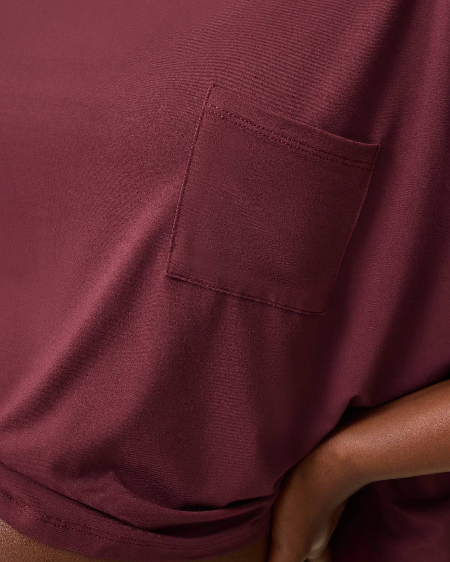 Close up of pocket detail on Aria Bamboo Casual Cropped Short Sleeve Top in Deep Burgundy.