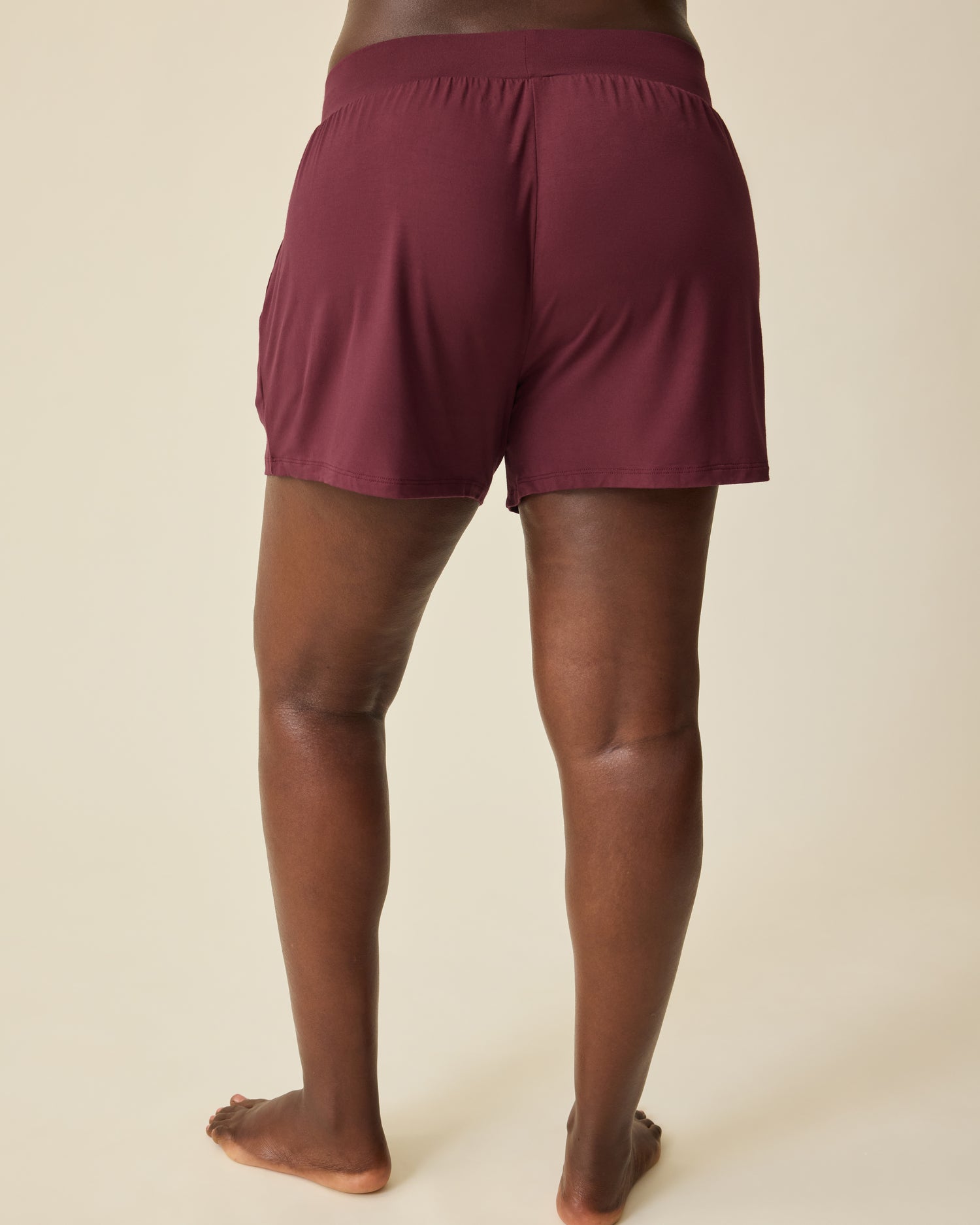 Back view of Aria Bamboo Casual Lounge Short in Deep Burgundy, on a beige background. 