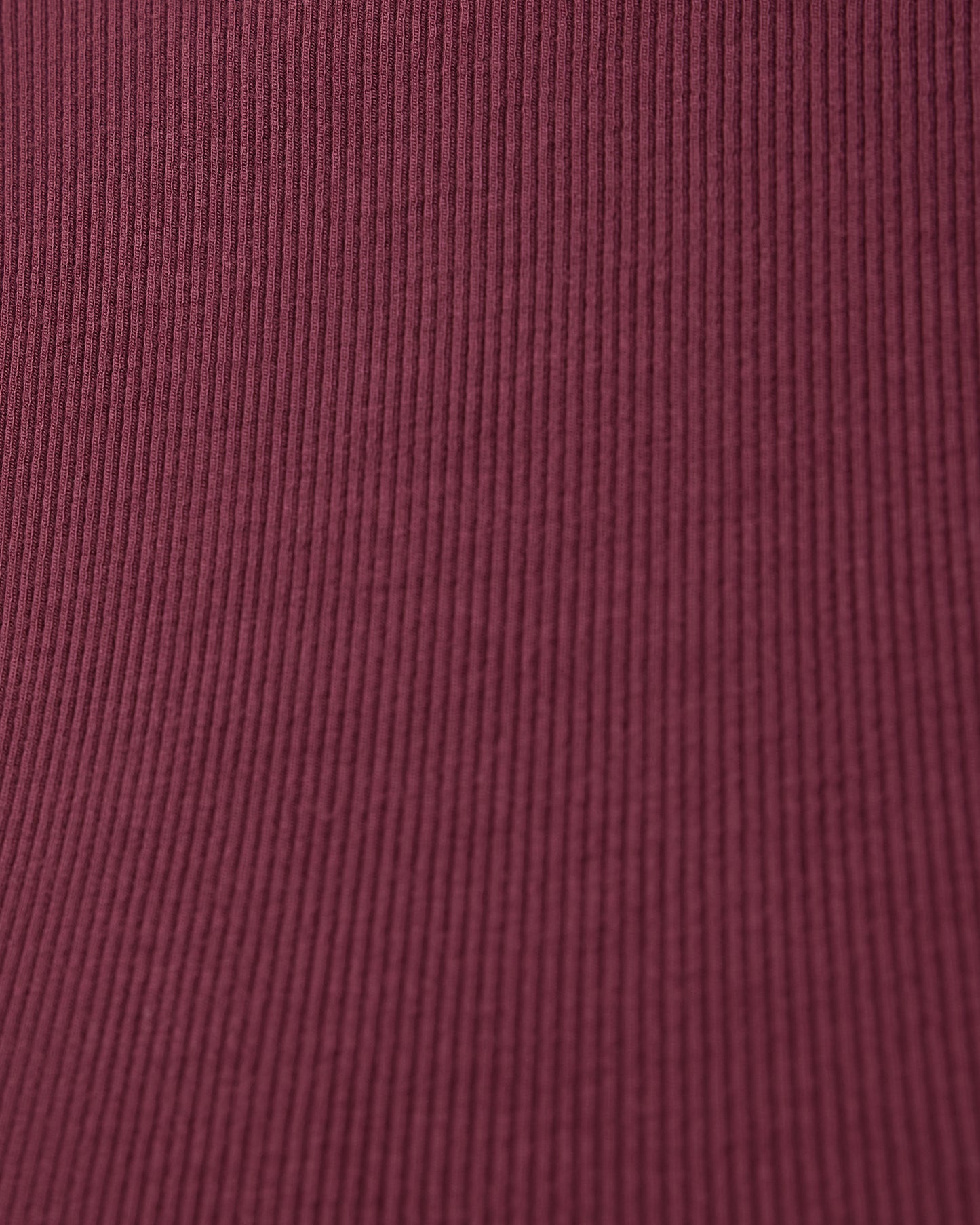 Close-up of a deep burgundy fabric from Ribbed Bamboo Racerback Nursing Tank