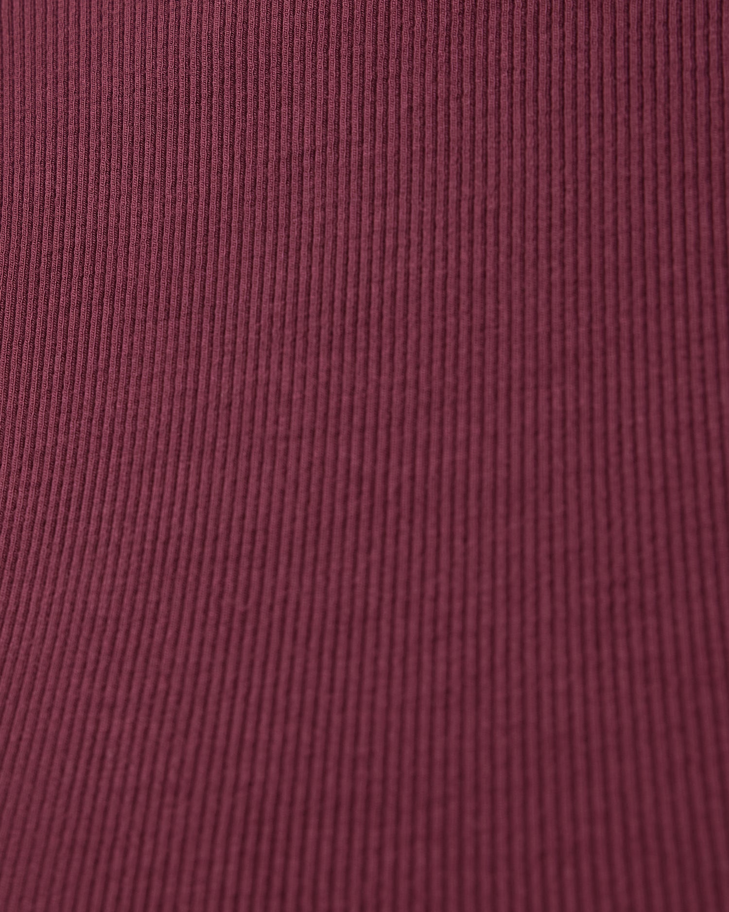 Close-up of a deep burgundy fabric from Ribbed Bamboo Racerback Nursing Tank