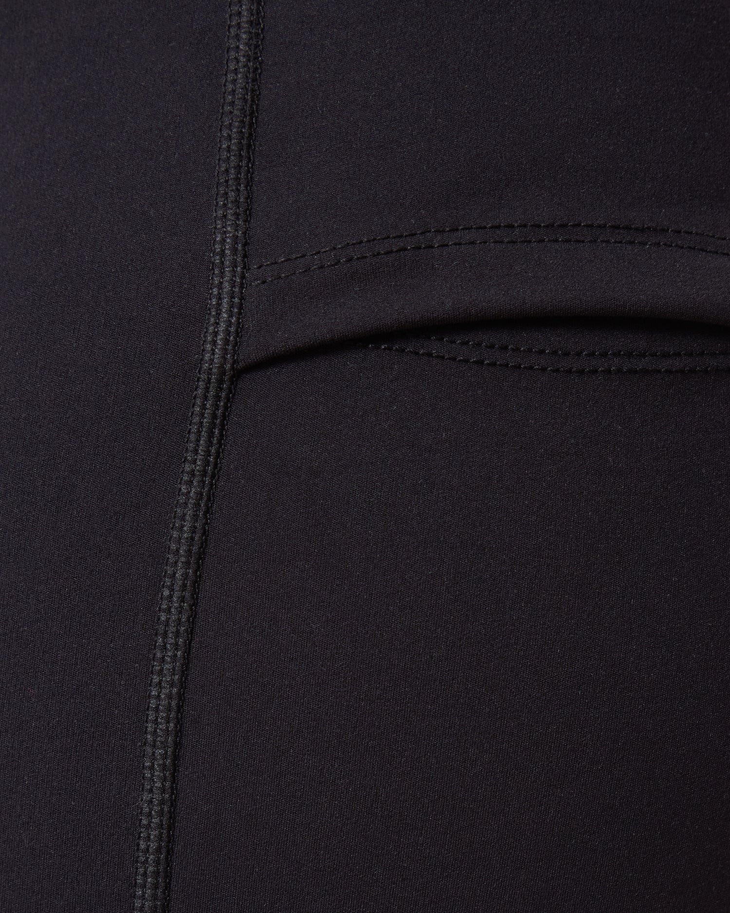 Close-up of a Stevie Active Postpartum Bike Short in black with a pocket detail