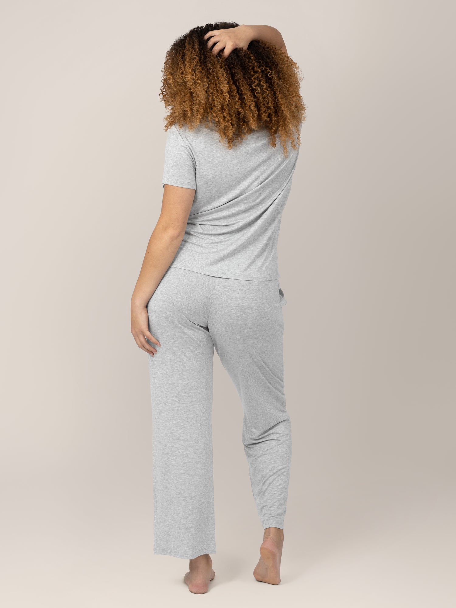 Back view of Model wearing the Tulip Hem Maternity and Nursing Pajama Set. 