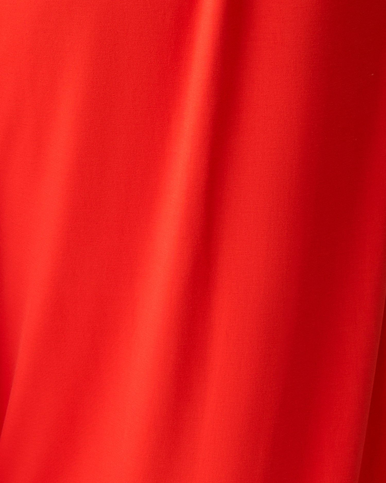Close-up of bright red fabric with visible texture