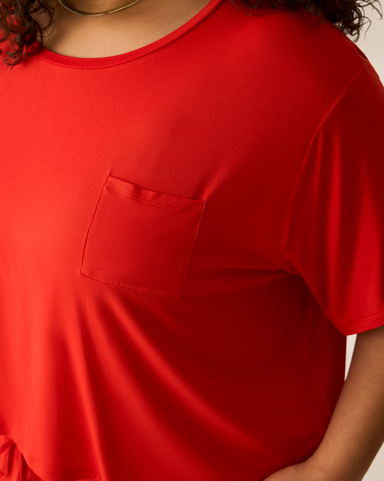 Bright red t-shirt with a pocket worn by a person