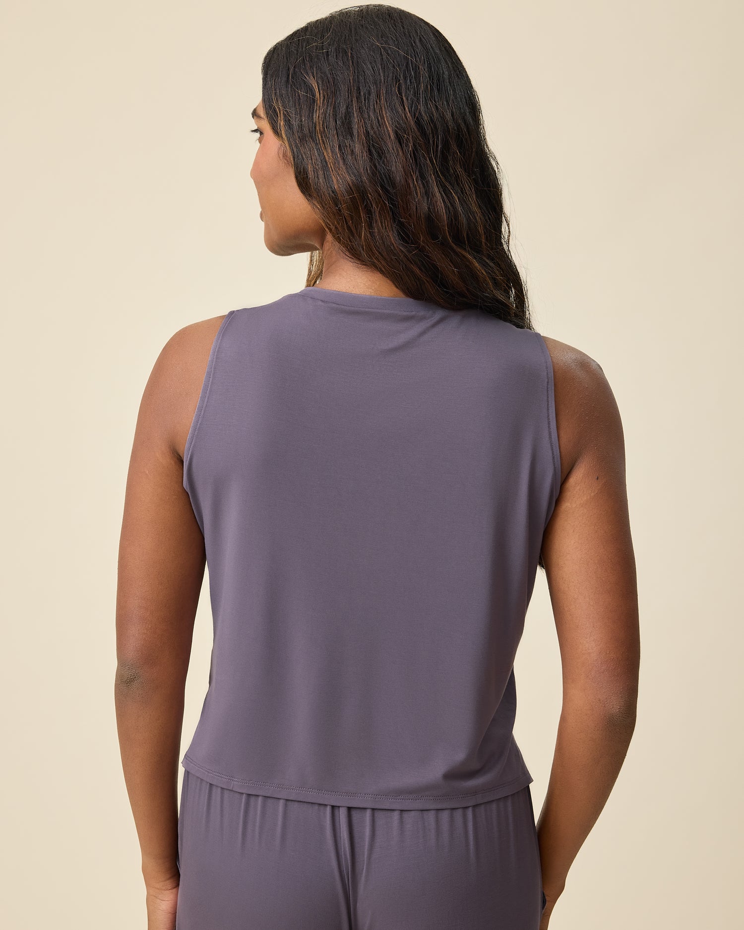 Back view of Aria Bamboo Cropped V-neck Tank in Granite and Aria Bamboo Casual Lounge Pant in Granite on a beige background.
