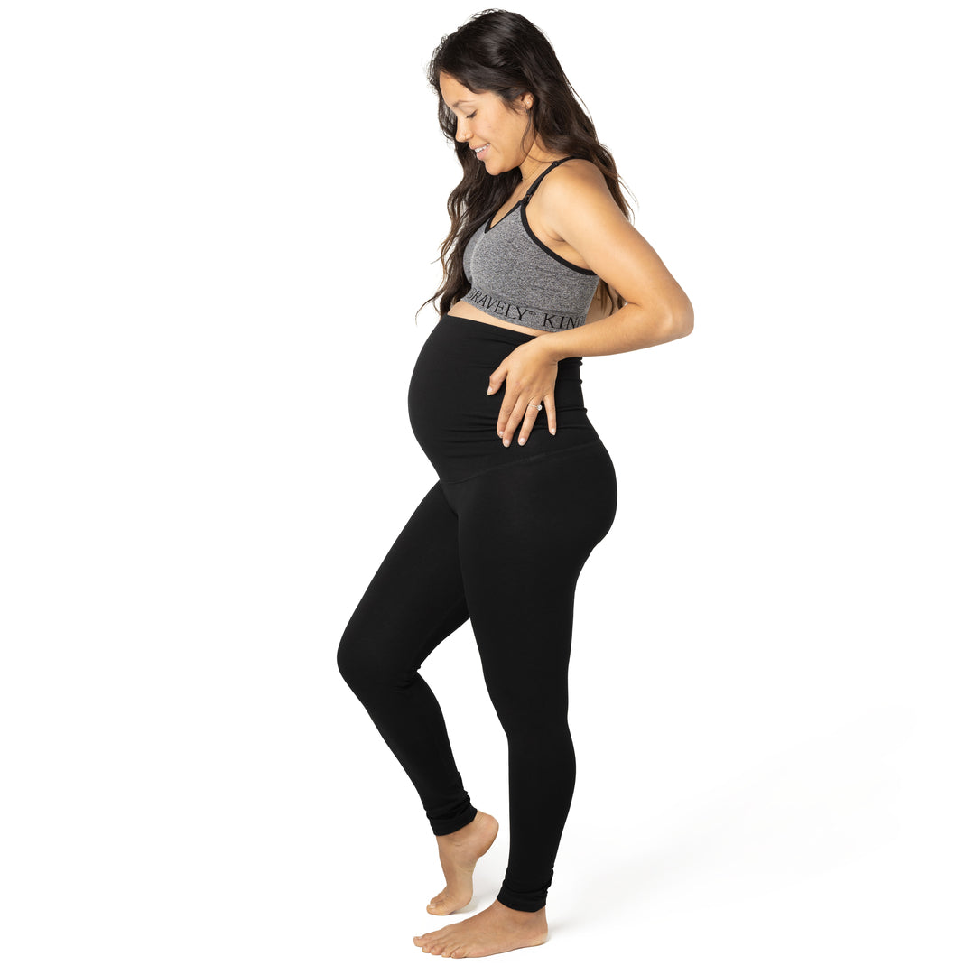Side view of model wearing the Cotton Maternity & Postpartum Footless Tight in black, with  Sublime® Nursing Sports Bra in  heather grey