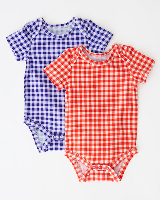 Baby Onesie Two-Pack in Red & Blue Gingham on a beige background