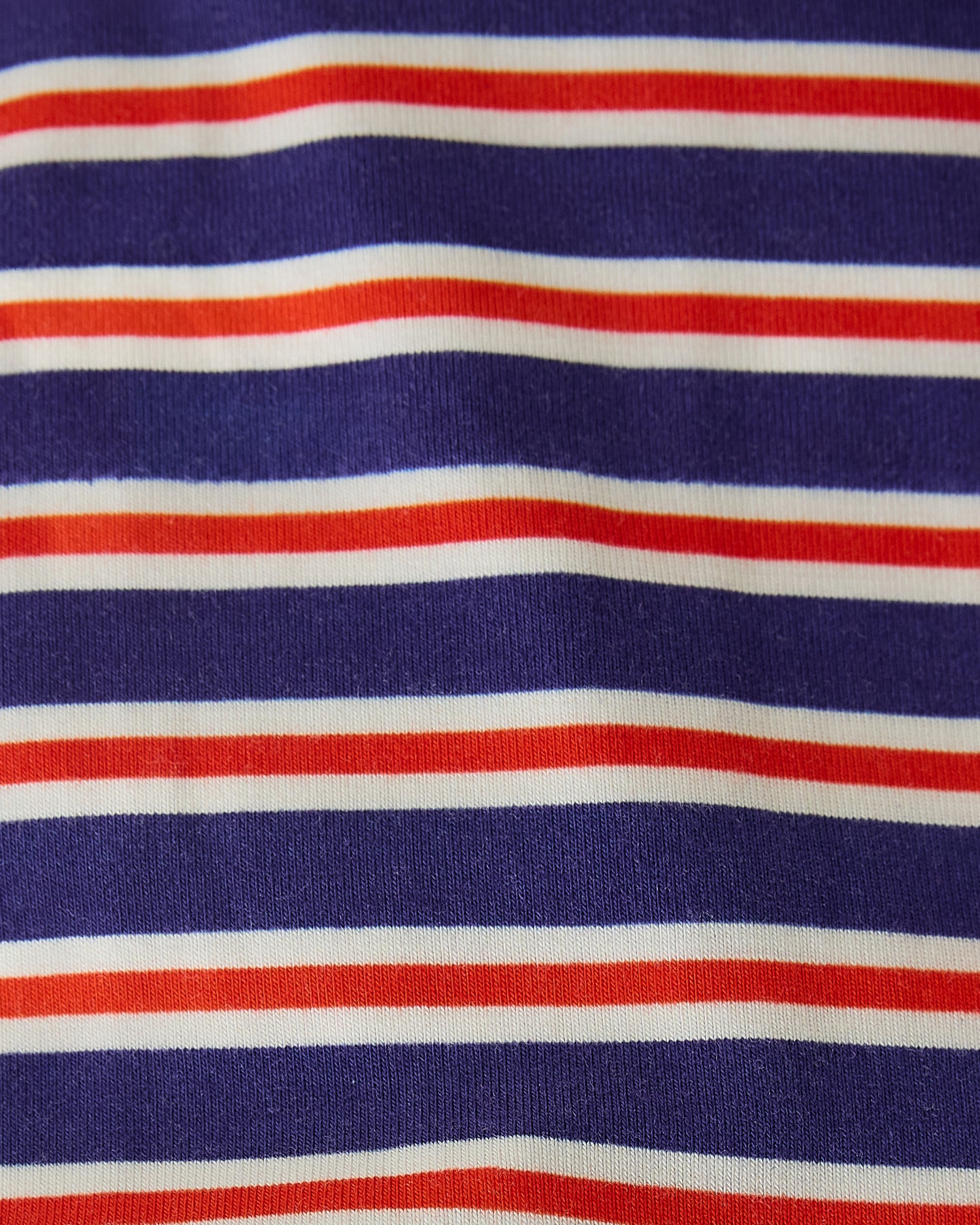 Close up of pattern on Baby Onesie Two-Pack in Red & Blue Stripe