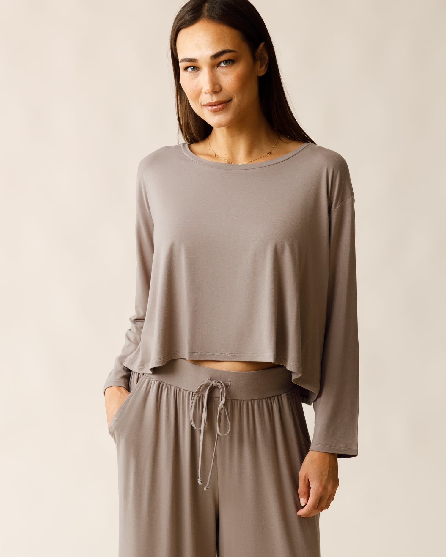 Woman wearing the Aria Bamboo Casual Cropped Long Sleeve Top in Taupe, paired with matching Aria Pant@model_info:Lisa is wearing a Small.