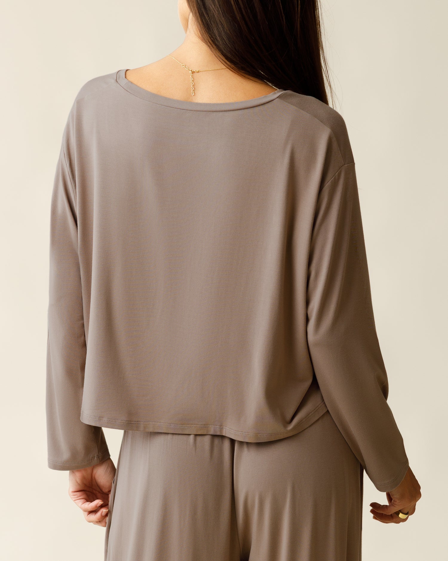Woman wearing the Aria Bamboo Casual Cropped Long Sleeve Top with matching bottoms, showing top from the back