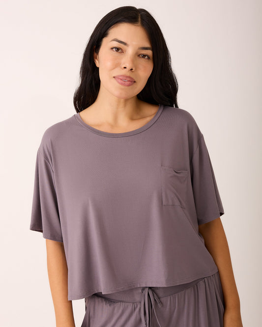 Model is wearing Aria Bamboo Casual Cropped Short Sleeve Top in Granite and Aria Bamboo Casual Lounge Pant in Granite on a beige background.@model_info:Ashley is wearing a Medium.