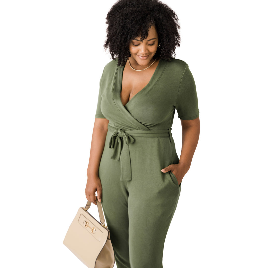 Model looking down while wearing the Around the Clock Nursing Jumpsuit in Olive. 
