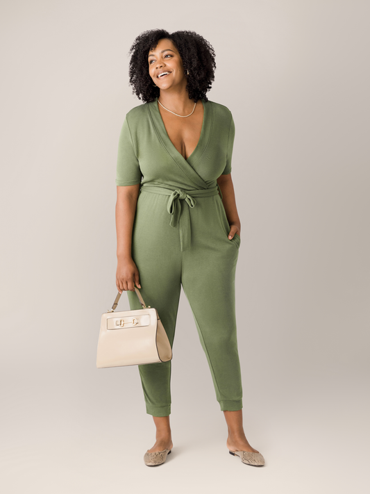 Model wearing the Around the Clock Nursing Jumpsuit in Olive with a bag.@model_info:Roxanne is 5'8" and wearing a Large.