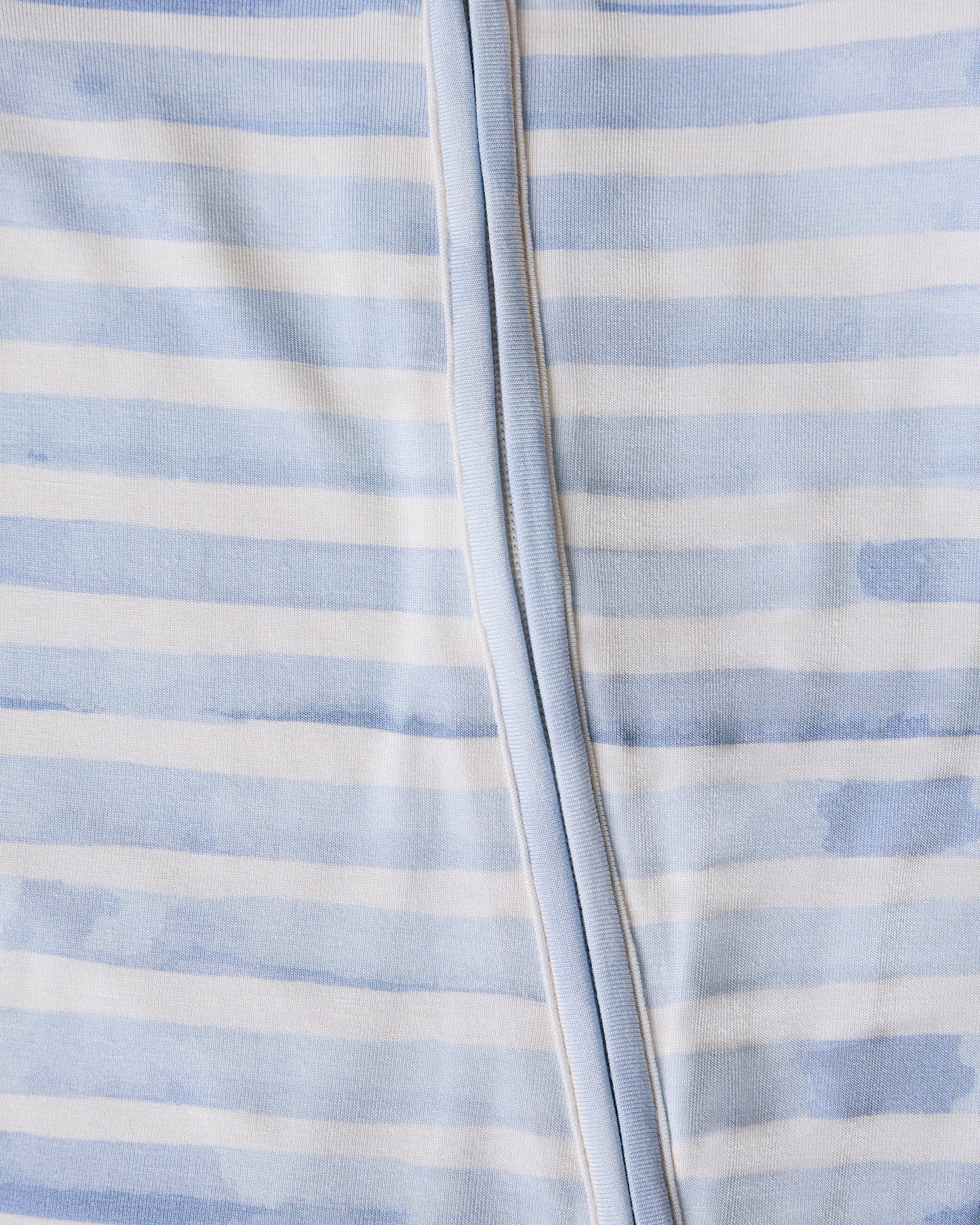 Close-up of a baby's Bamboo Baby Pajama  in blue watercolor with blue and white striped pattern