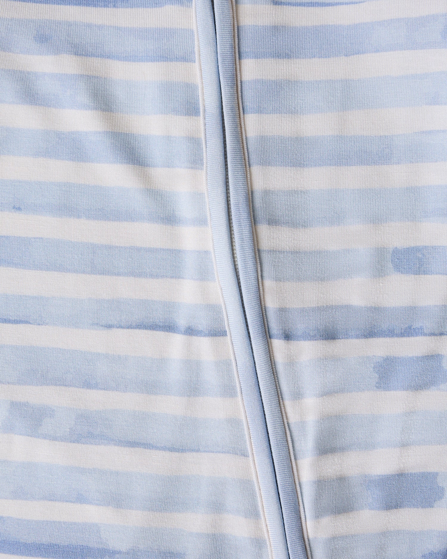 Close-up of a baby's Bamboo Baby Pajama  in blue watercolor with blue and white striped pattern