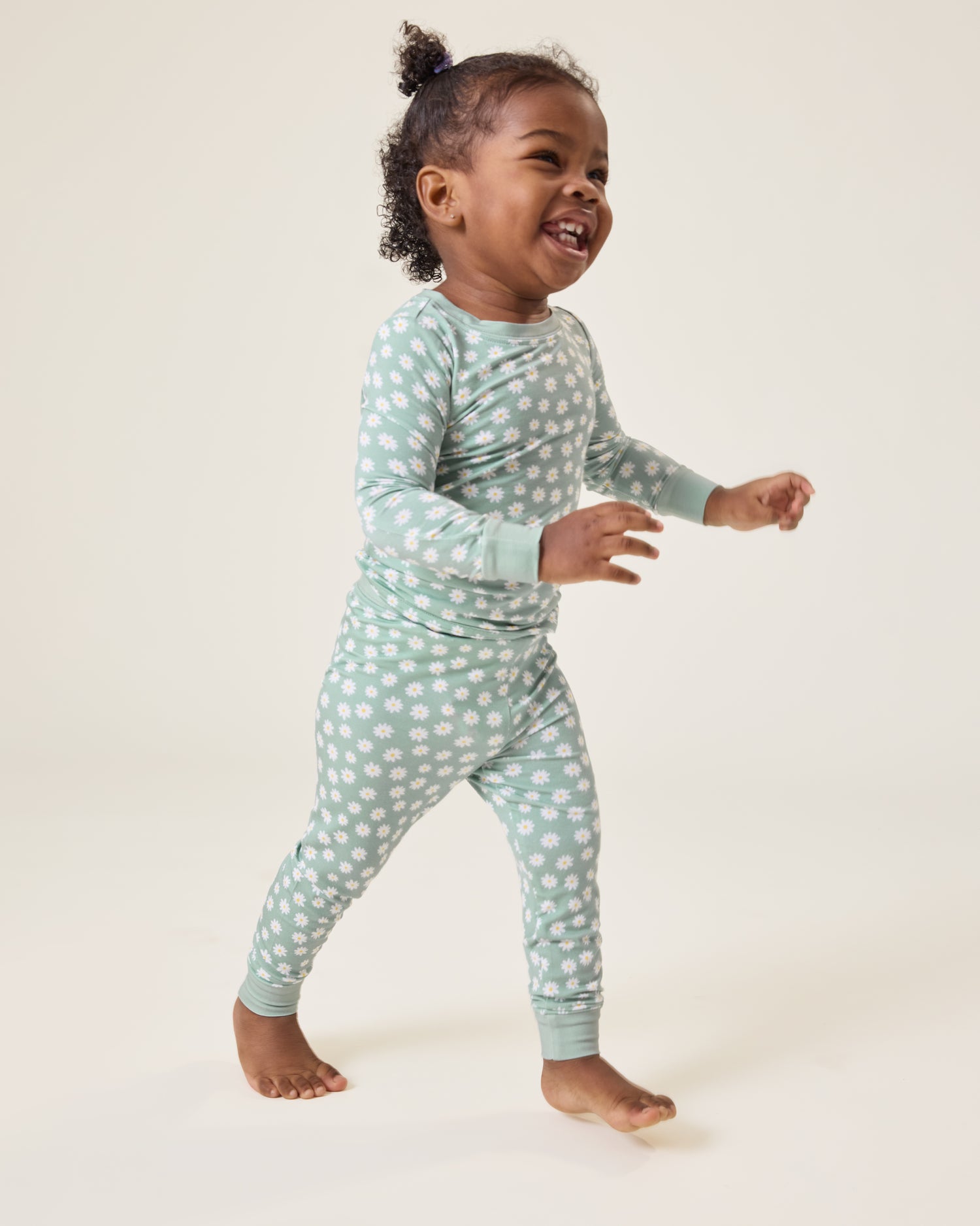 Baby wearing the Bamboo Baby Two-Piece Pajama Set in Sage Daisies print@model_info:Harper is wearing 18-24 months.